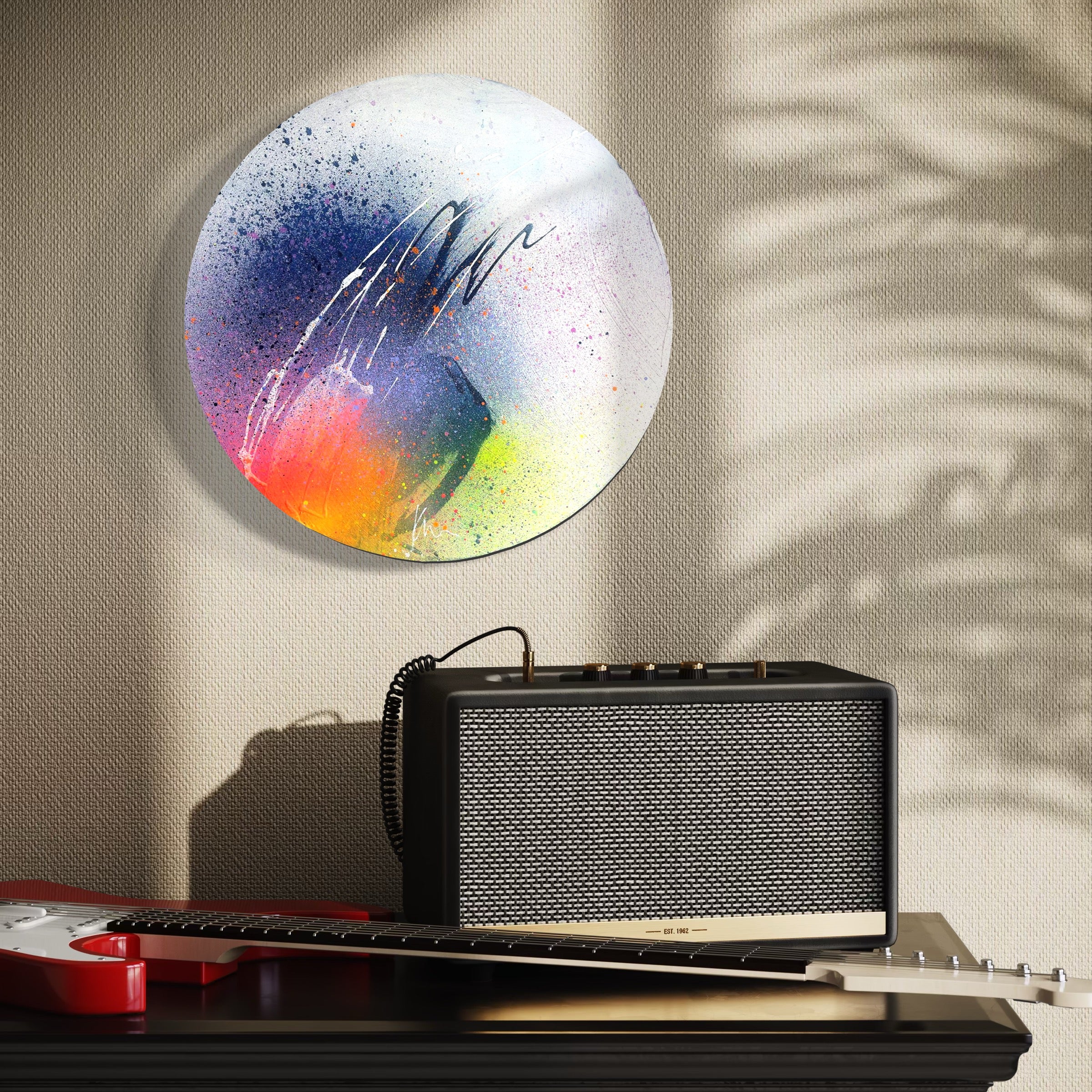 Kate Mayer's "Right Here, Right Now" painting, a vintage black speaker, and a red electric guitar adorn the nearby table.
