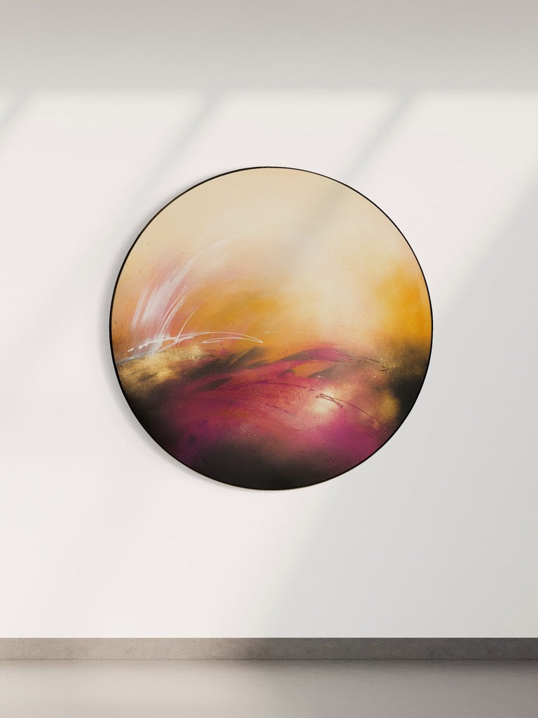 “It’s Alright, I Feel It” by Kate Mayer: yellow, orange, and magenta acrylic round art glows on a white wall.
