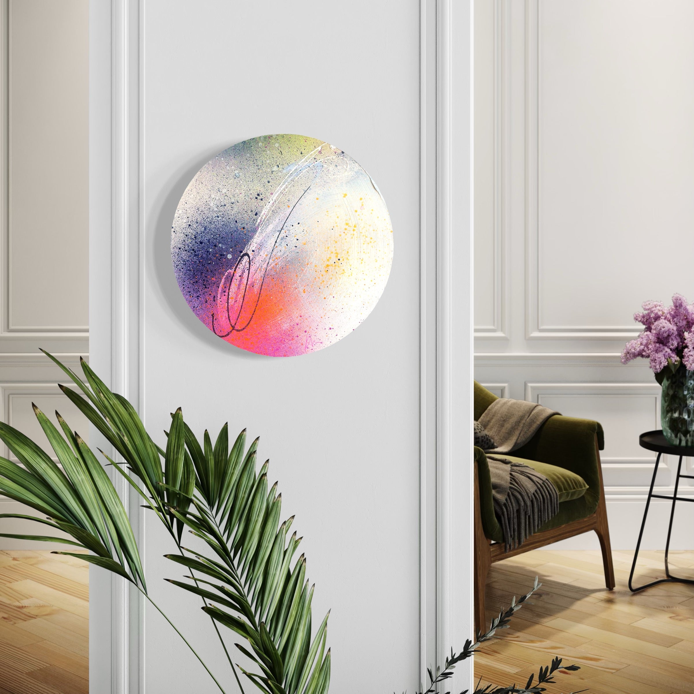 We Only Ever Have Now" by Kate Mayer on a round plywood panel, near plants and a chair in a bright room.