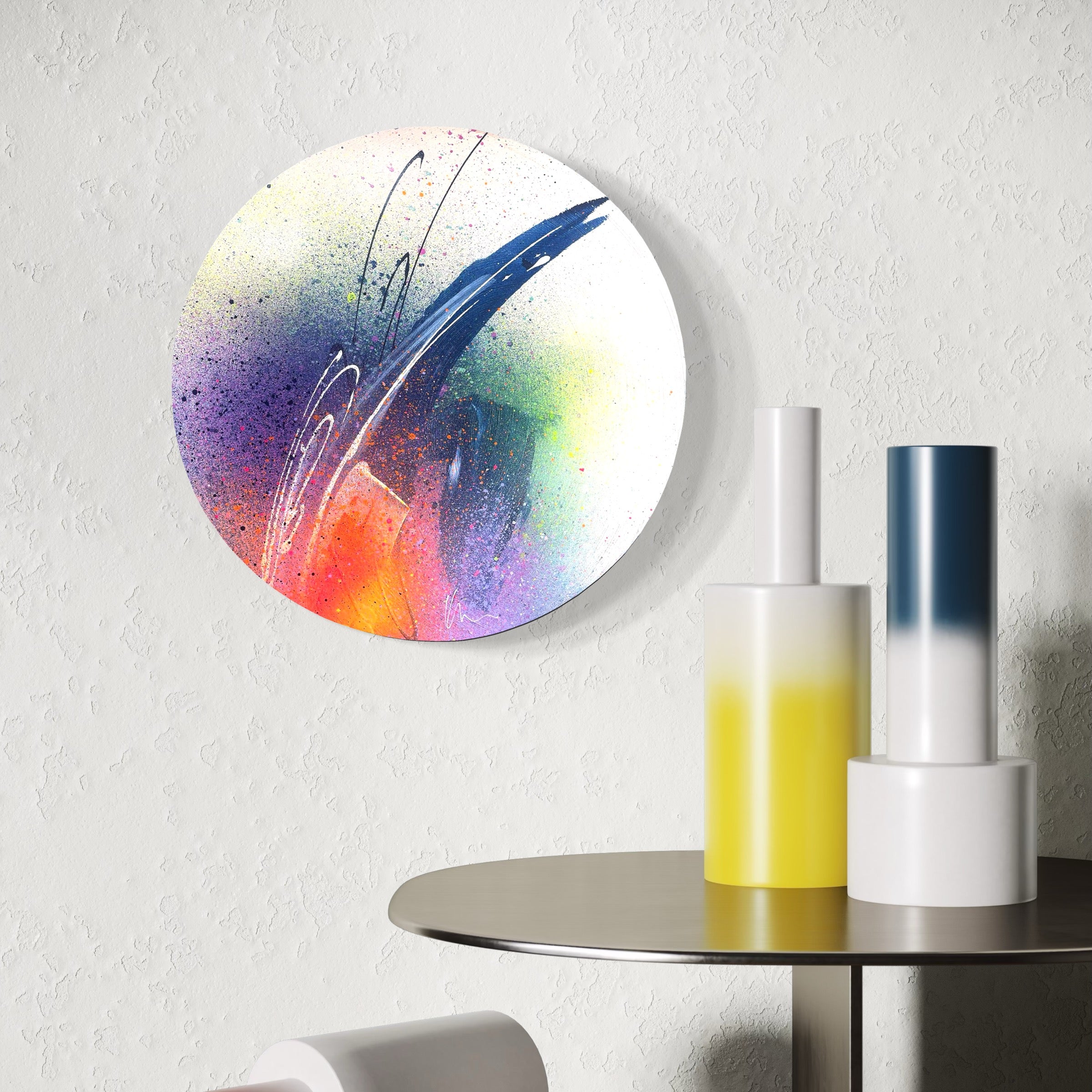 Kate Mayer's 'You've Got The Power' painting on a white wall, with sleek cylinders on a round table.