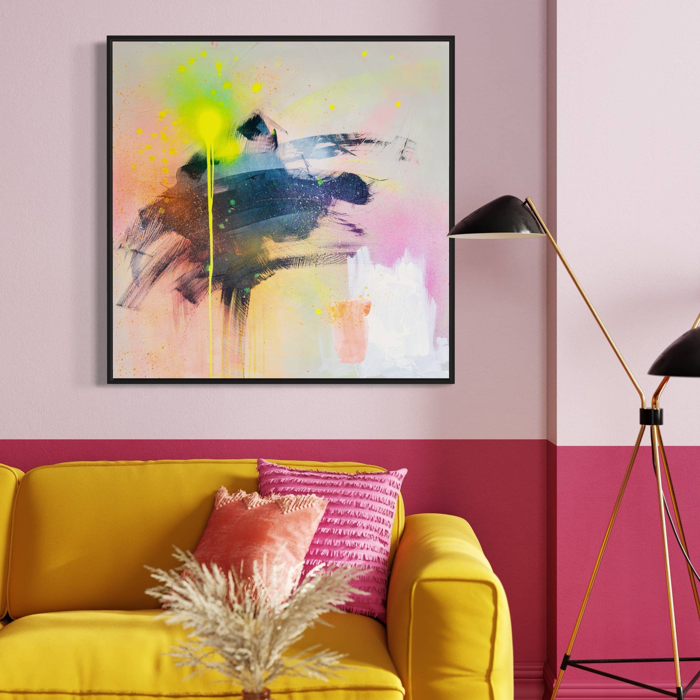 A modern living room featuring a yellow sofa, pink and red cushions, a black lamp, and Kate Mayer's Miami Vibes - Original Painting on the wall captures an art vibe inspired by Miami.