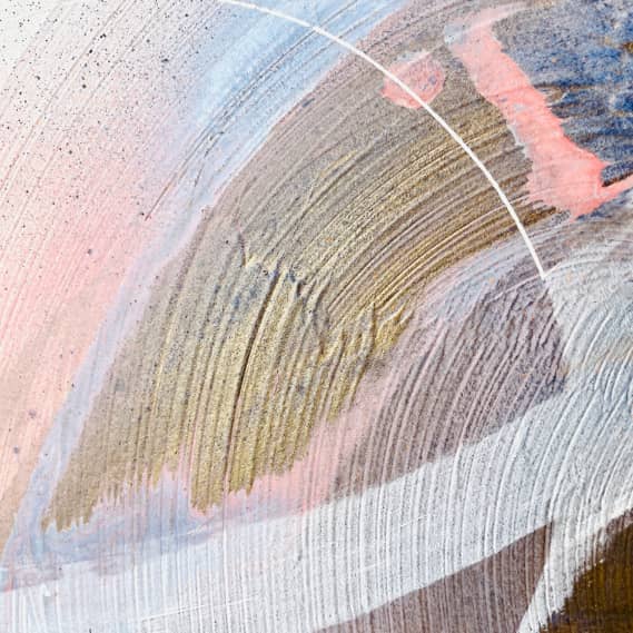 Just Be," an abstract painting by Kate Mayer, features swirling brushstrokes in shades of pink, blue, gold, and white with curved white lines crafted using acrylic and spray paint.