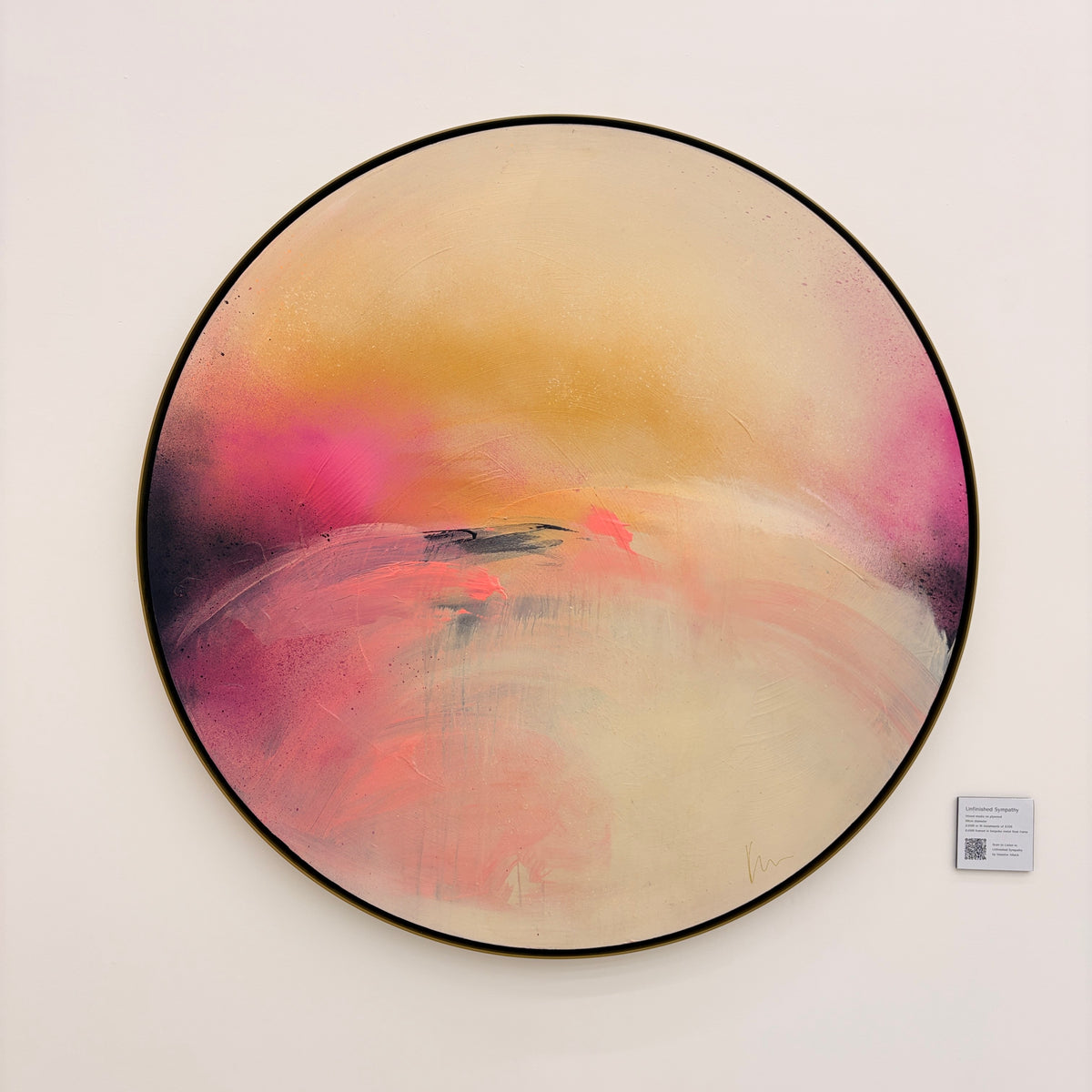 Unfinished Sympathy“ by Kate Mayer: circular acrylic painting in pink, yellow, and cream, framed in handmade metal.