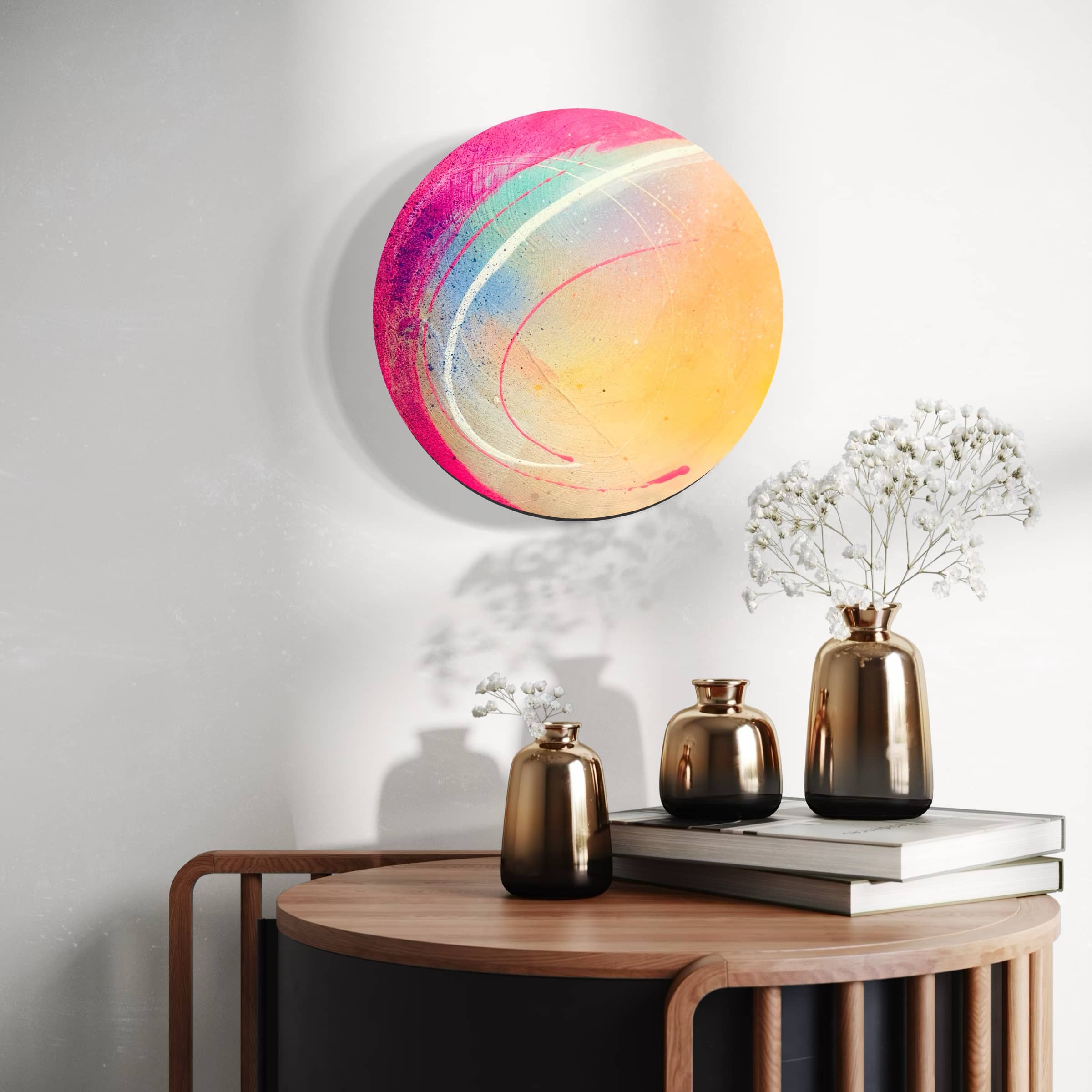 The "Be Colourful" painting by Kate Mayer hangs above a small table with metallic vases and books.