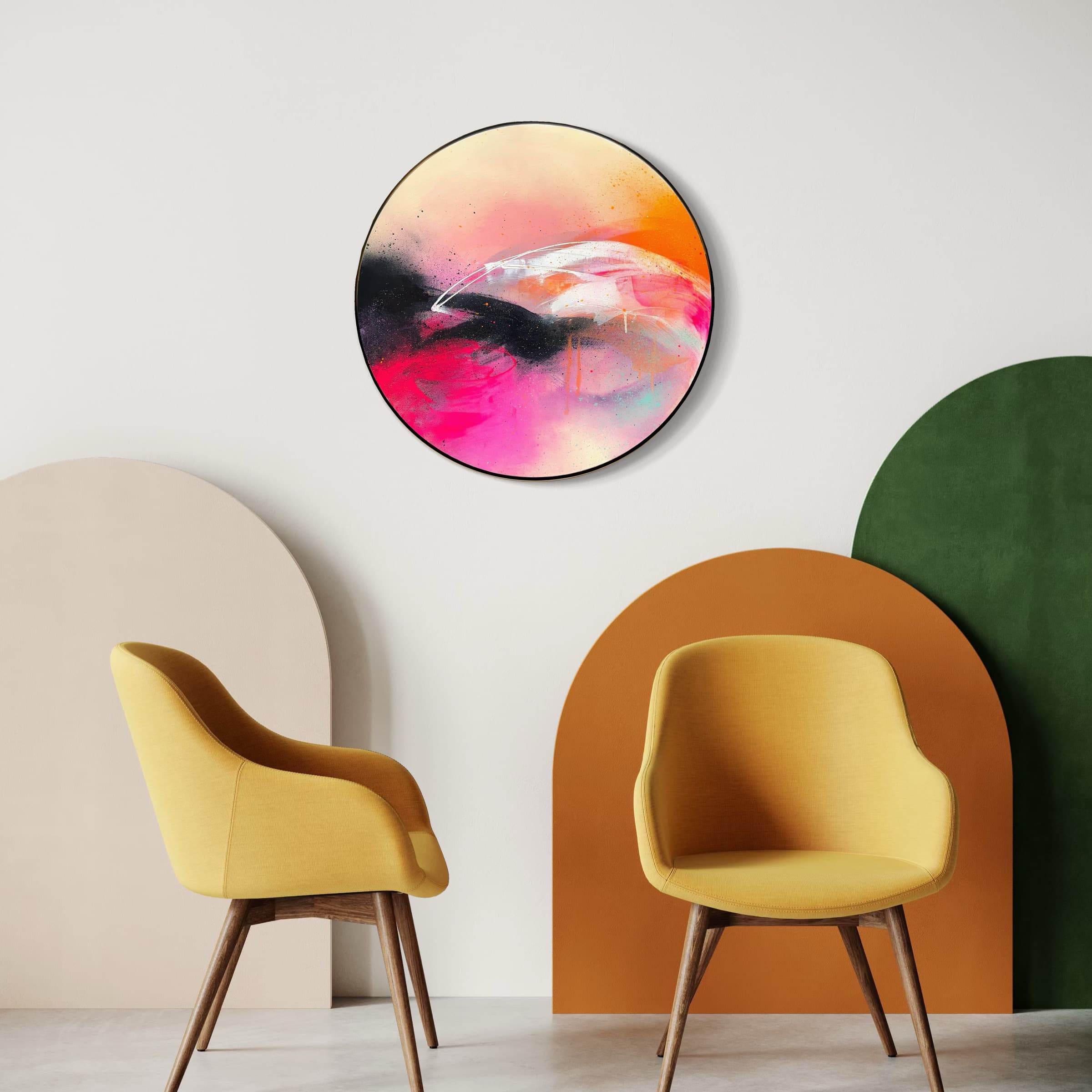 Two yellow chairs face a room with colorful arches and "Feels Like Magic" by Kate Mayer in a bespoke frame.