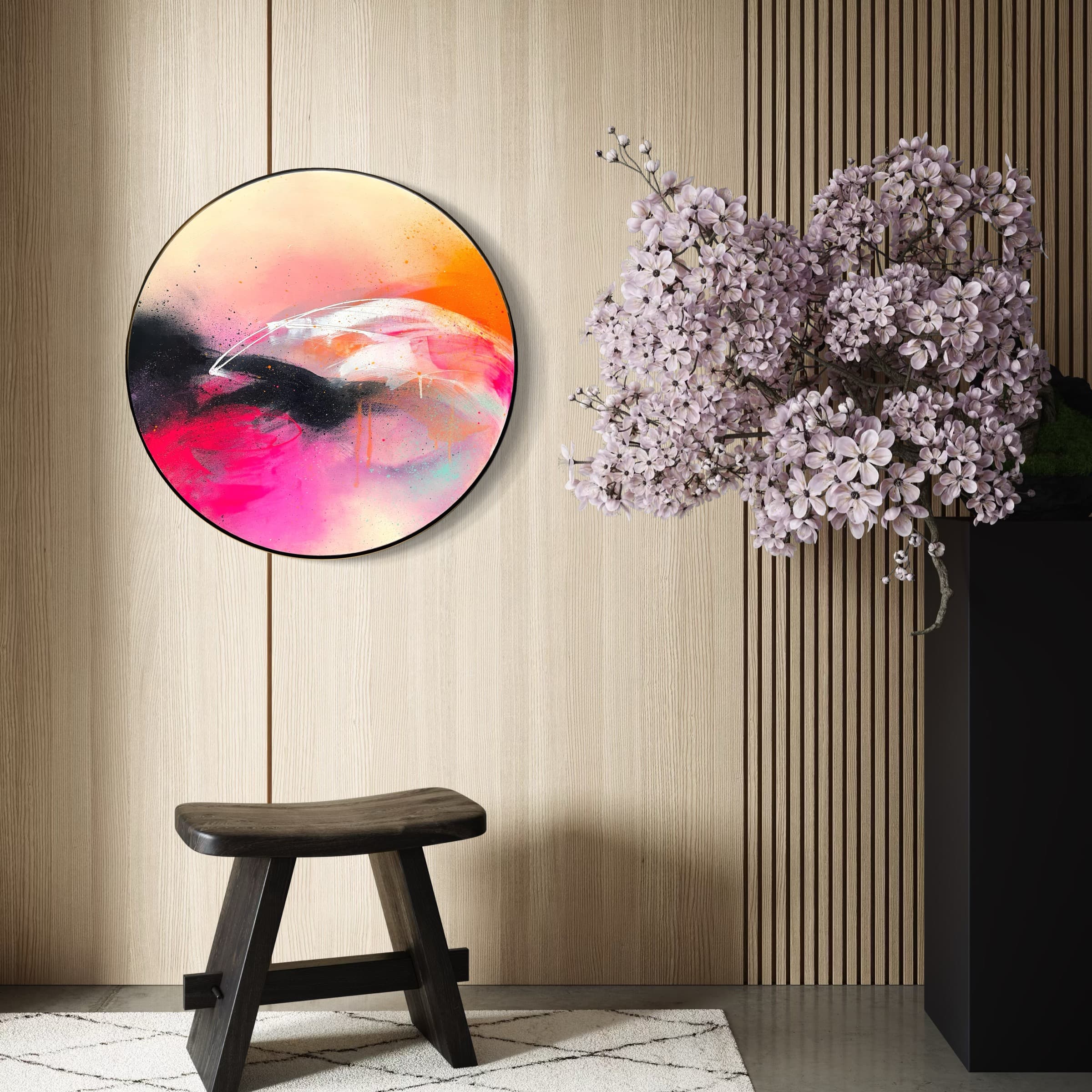 Feels Like Magic," a Kate Mayer abstract painting in pink, orange, and black with a custom frame; stool and branch nearby.