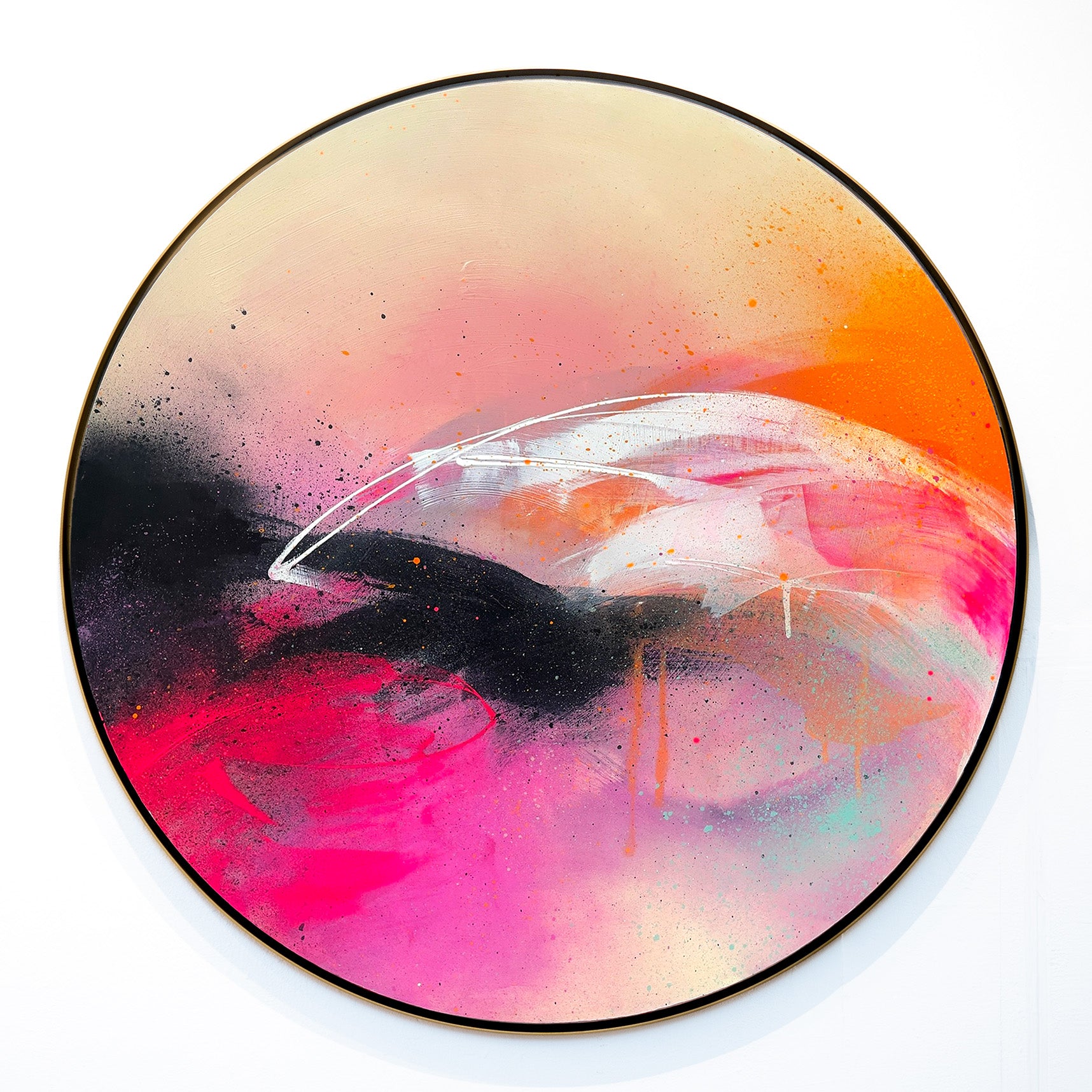 The "Feels Like Magic" circular painting by Kate Mayer features pink, orange, and black swirls with dynamic brushstrokes.