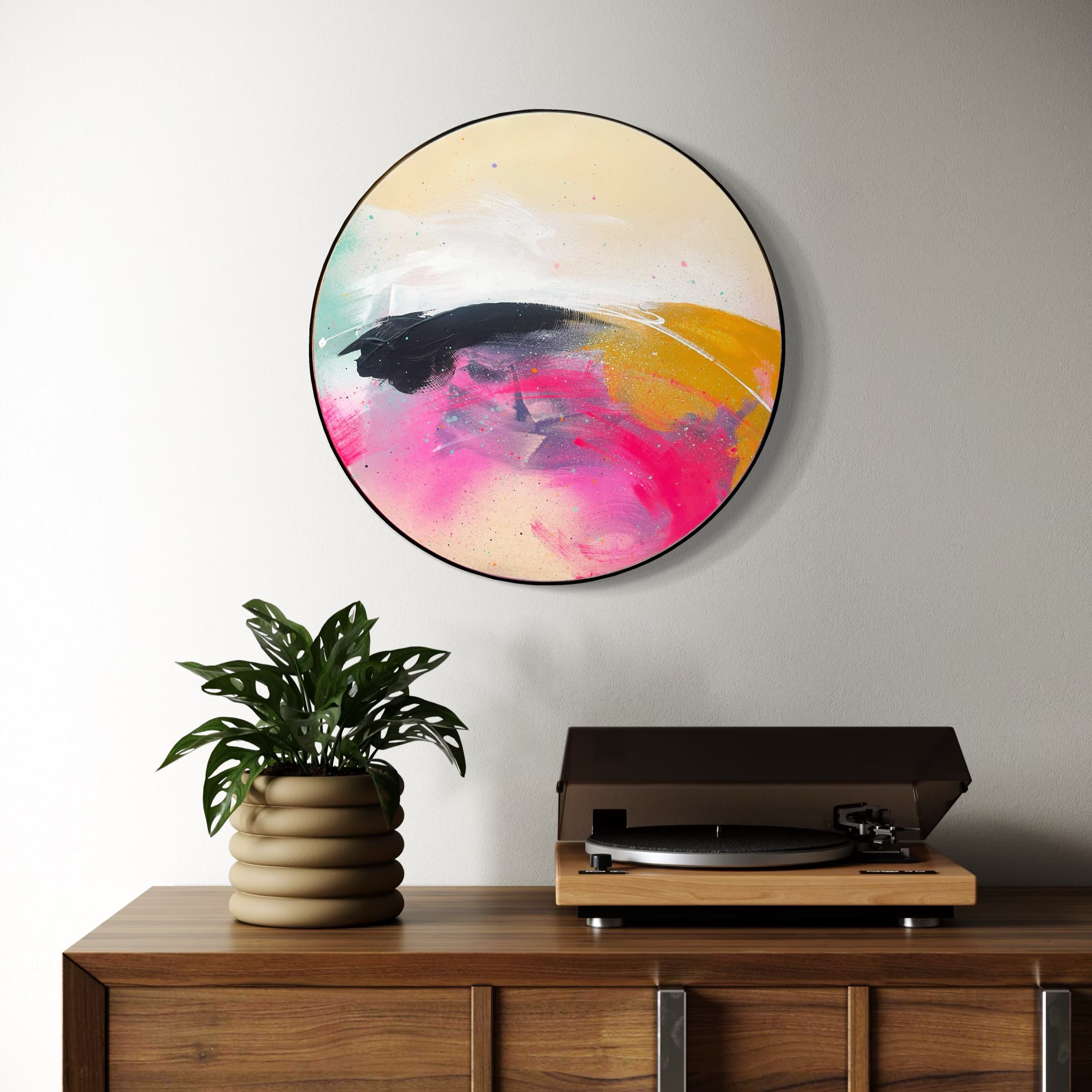 Move On Up by Kate Mayer, a round abstract painting on plywood, hangs above a wooden console with record player and plant.