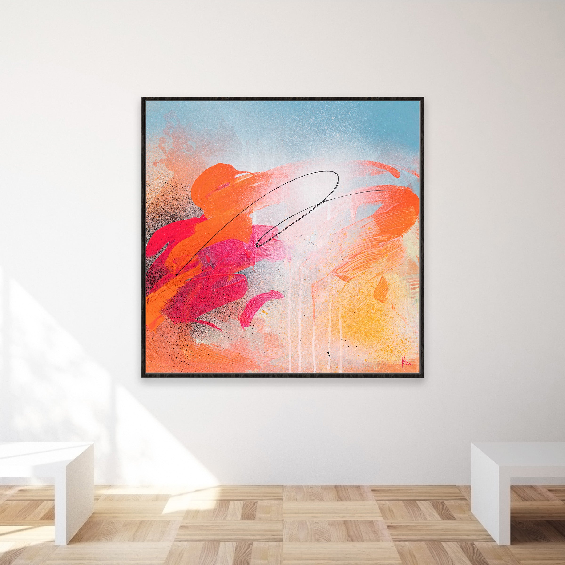 The "Dance With Me" artwork by Kate Mayer showcases joyous art with vibrant orange, pink, and blue brushstrokes set against a light background, elegantly framed on a white gallery wall.
