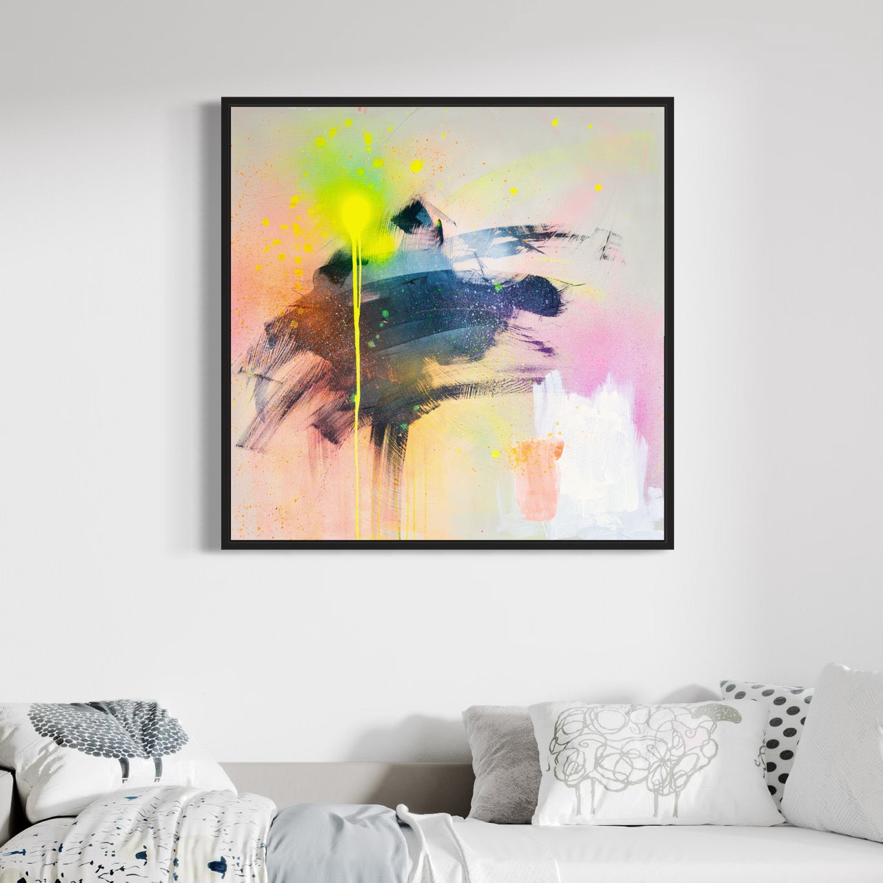 The "Miami Vibes - Original Painting" by Kate Mayer adds vibrancy to the room with its colorful abstract design, showcasing bold brush strokes and splashes of yellow on a light wall above a bed adorned with patterned pillows.