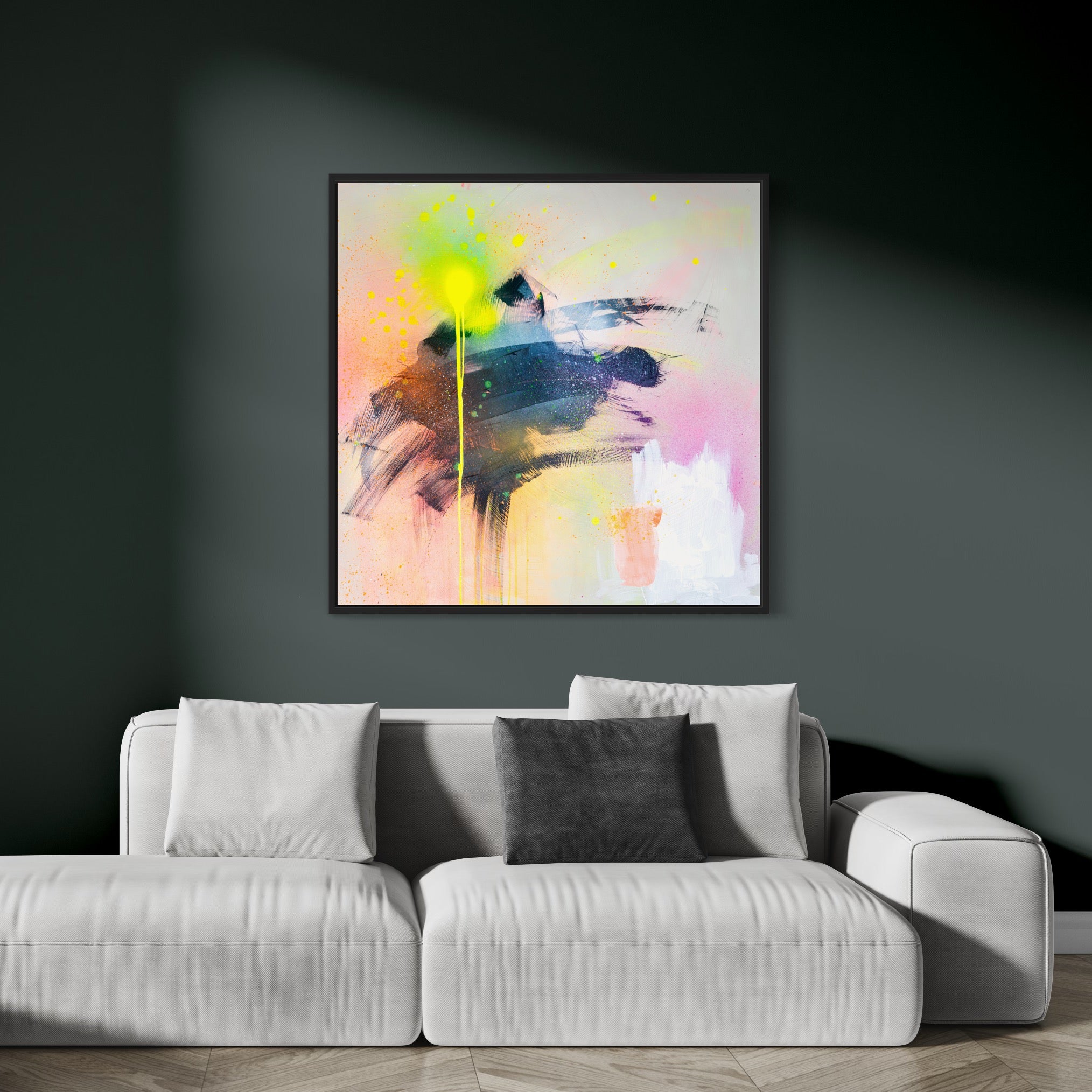 The "Miami Vibes - Original Painting" by Kate Mayer, rich with vibrant colors, is displayed on a dark green wall above a white sofa adorned with two gray pillows.