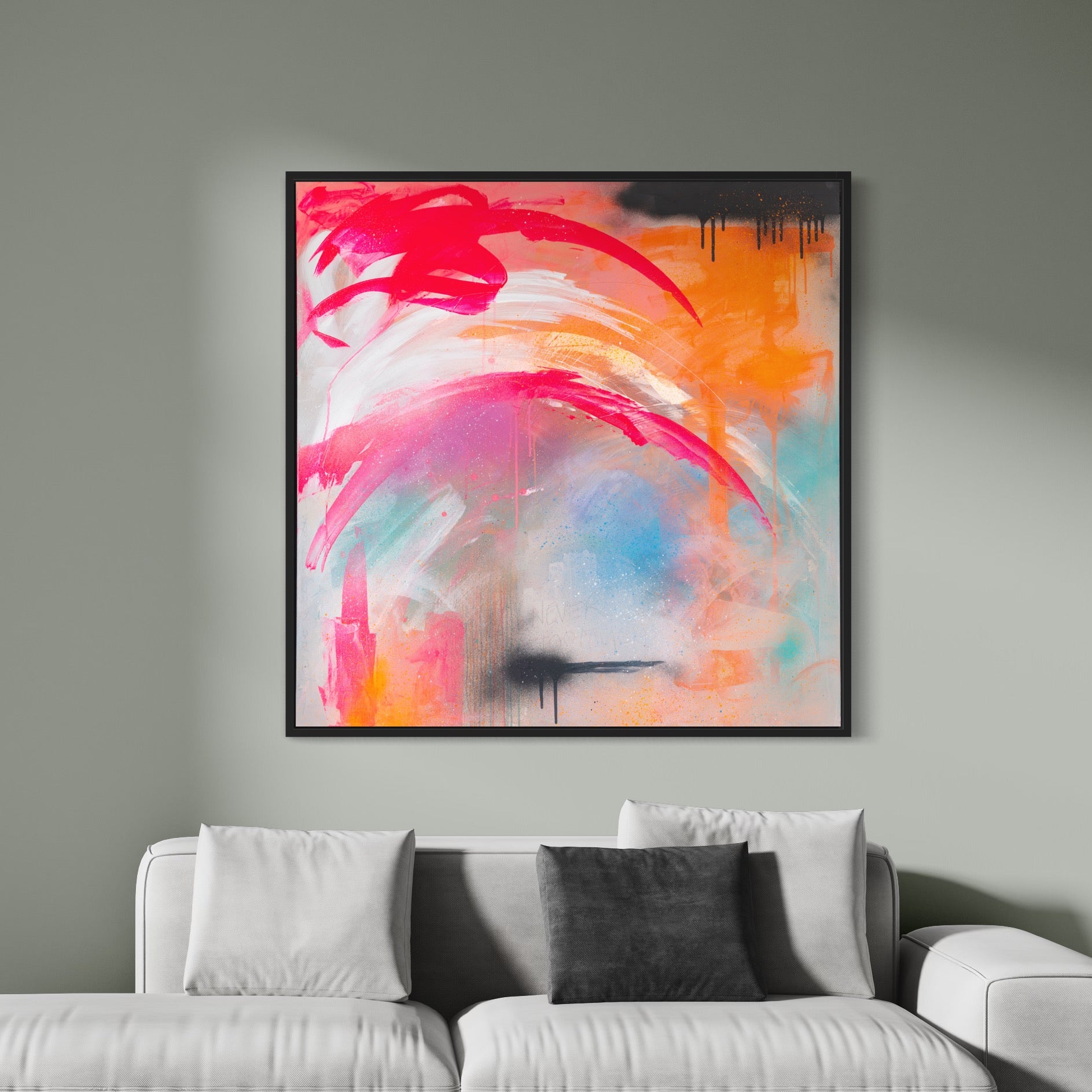 The "Never Too Much - Original Painting" by Kate Mayer, featuring vibrant swirls of pink, orange, and black in acrylic and spray paint, hangs elegantly above a light gray sofa adorned with cushions.