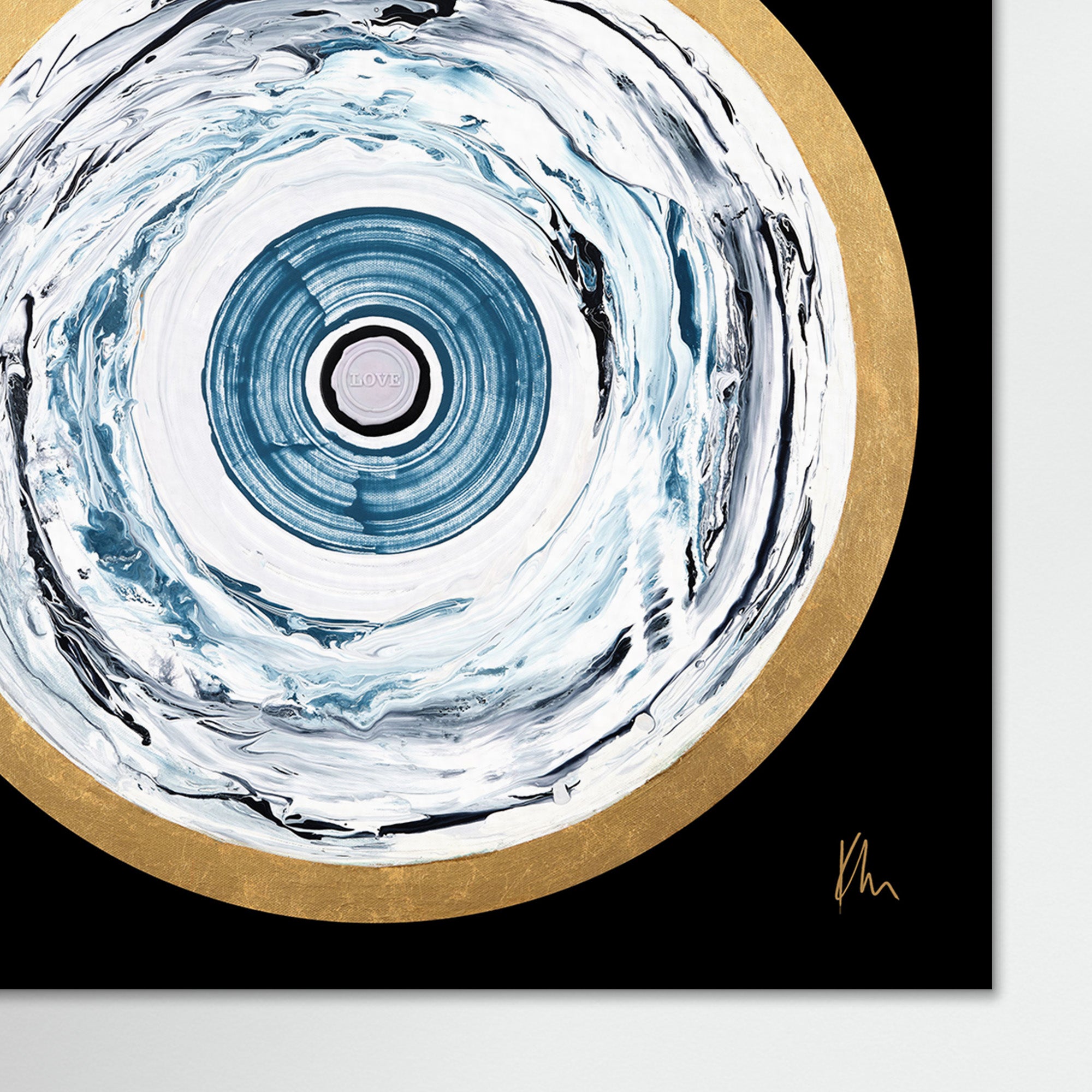 The One Love print by Kate Mayer showcases an abstract art piece of concentric circles, featuring blue and white swirls encircled by a golden outer ring against a black background.