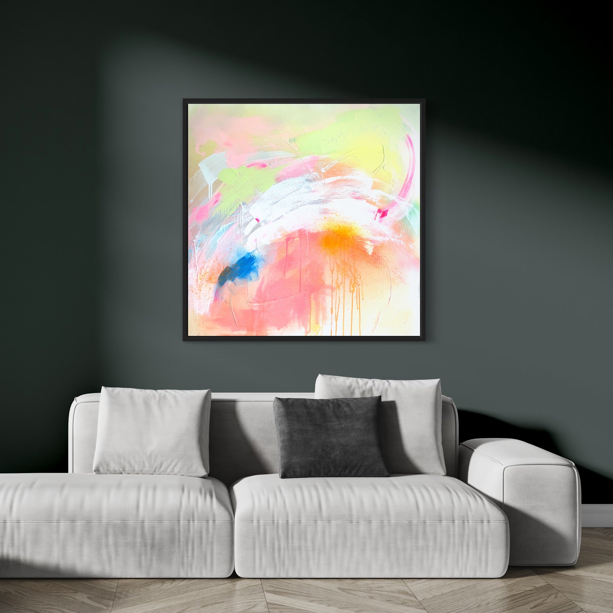 Pure Joy - Original Painting by Kate Mayer showcases vibrant colors, crafted with acrylic and spray paint on canvas, and is elegantly presented in a black wooden float frame. It's displayed on a dark green wall above a white couch with a gray pillow.