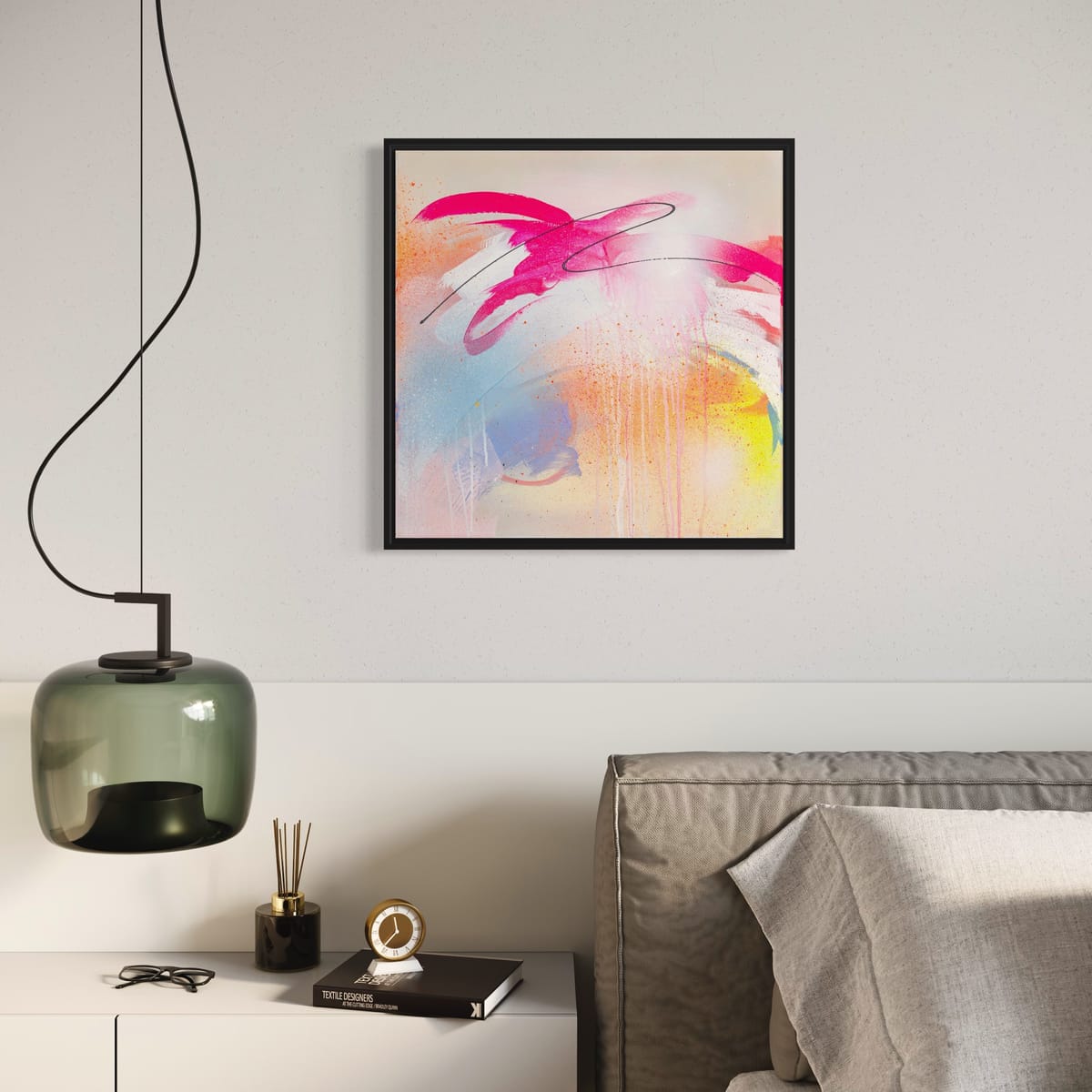 A modern bedroom features the "Hell Yeah" original painting by Kate Mayer on the wall, a gray bed, and a sleek lamp on a white nightstand.