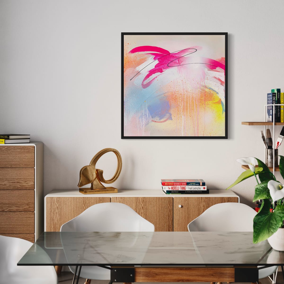 A contemporary dining room showcasing the *Hell Yeah* original painting by Kate Mayer, highlighting dynamic colors with fluorescent paint. The area is enhanced by a glass table, white chairs, and minimalist decor.