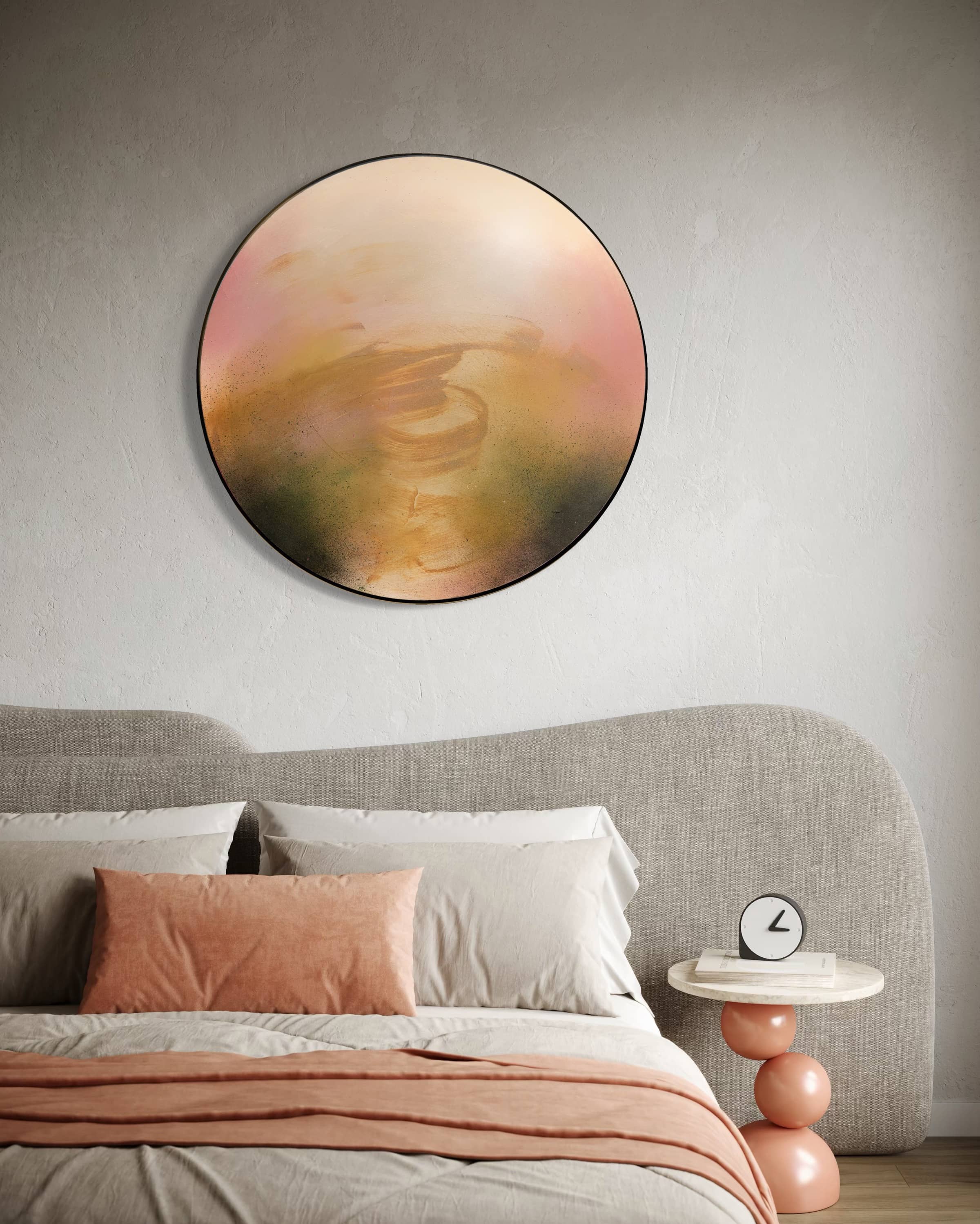 A modern bedroom with Kate Mayer's "Kindling" above the bed, peach accents, and a round side table with a clock.