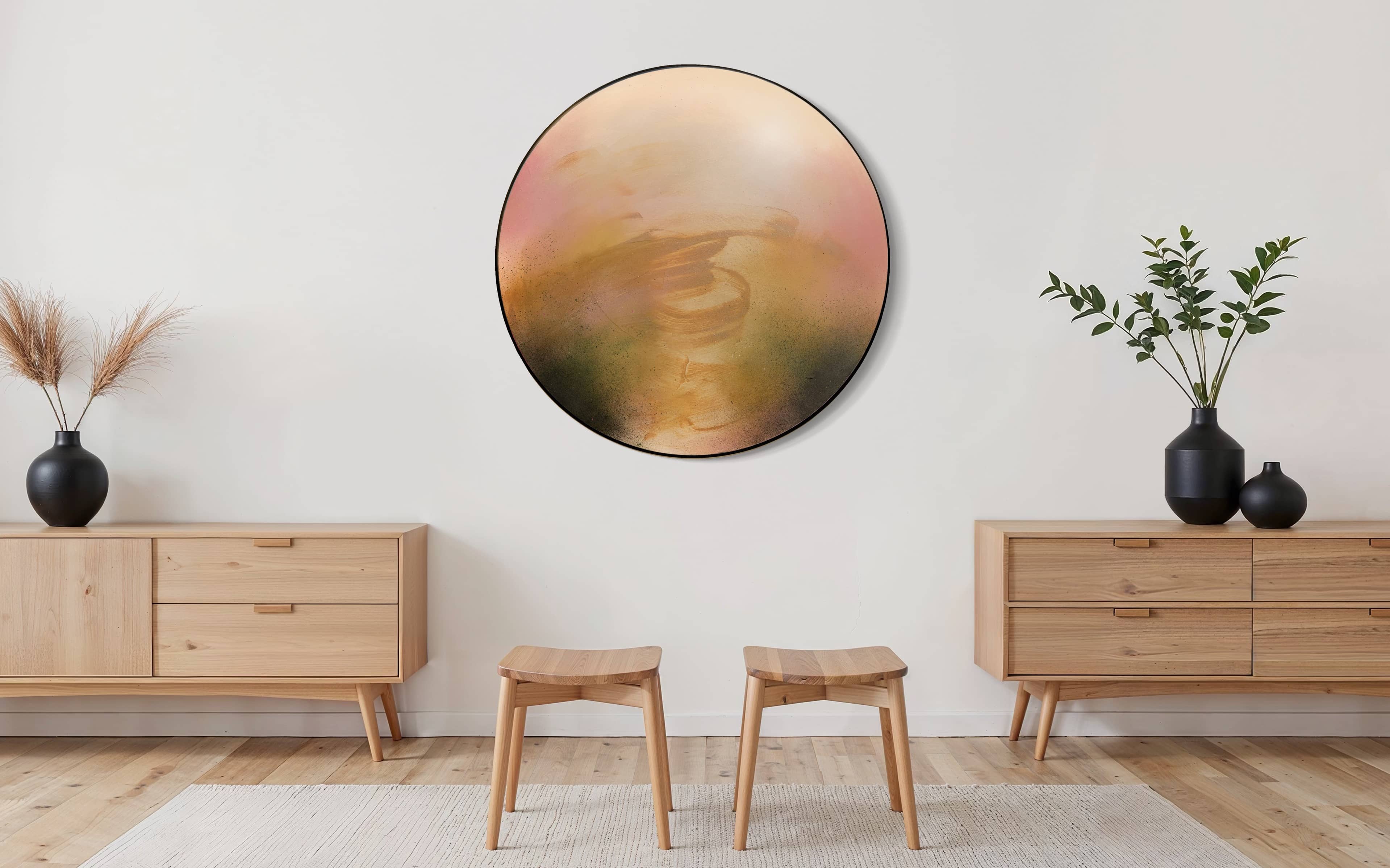 Minimalist room with two stools, wood cabinets, plants, and the Kindling art piece by Kate Mayer on a white wall.