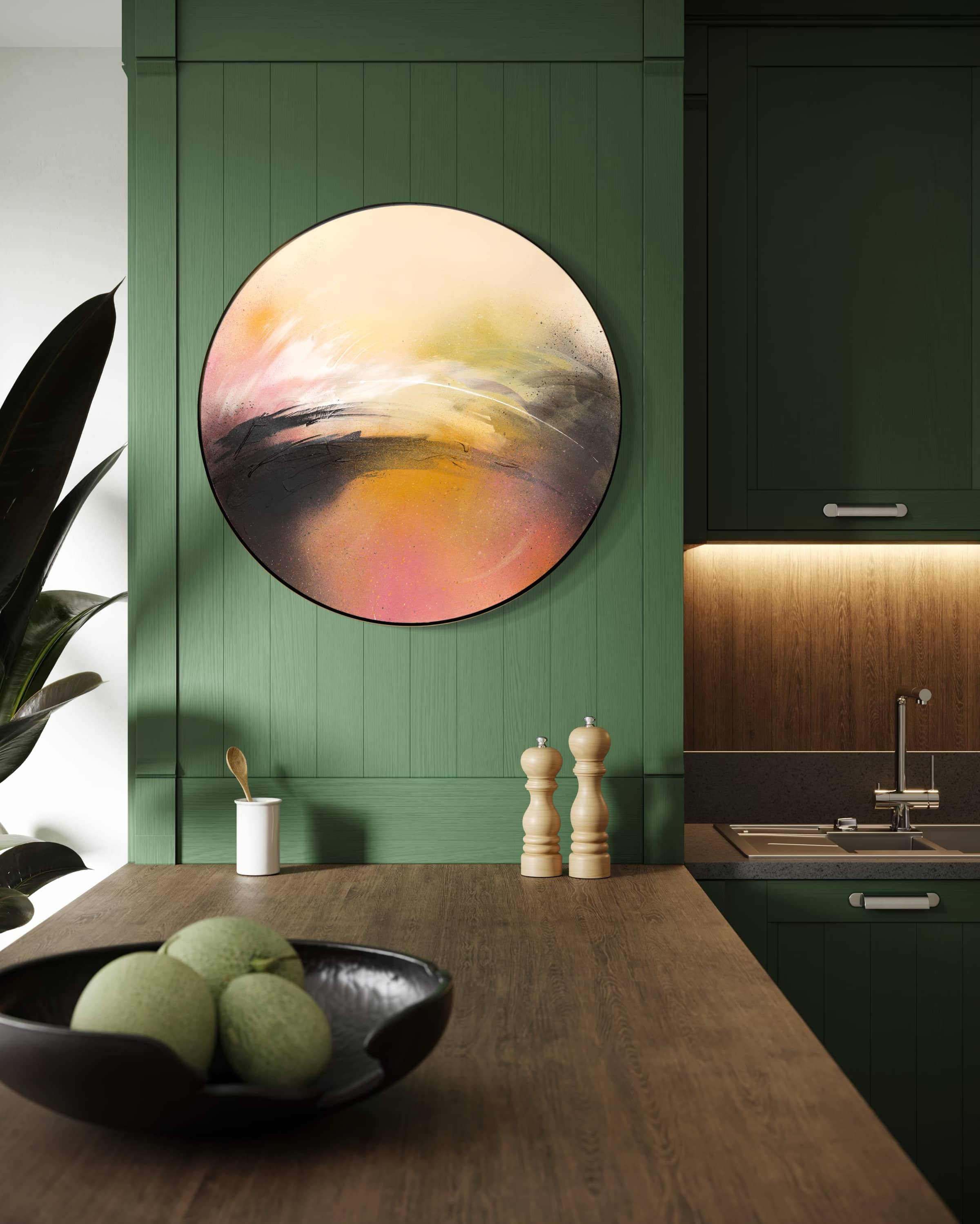 One Day Like This" by Kate Mayer hangs on a green kitchen wall above a wood counter and bowl of green fruit.