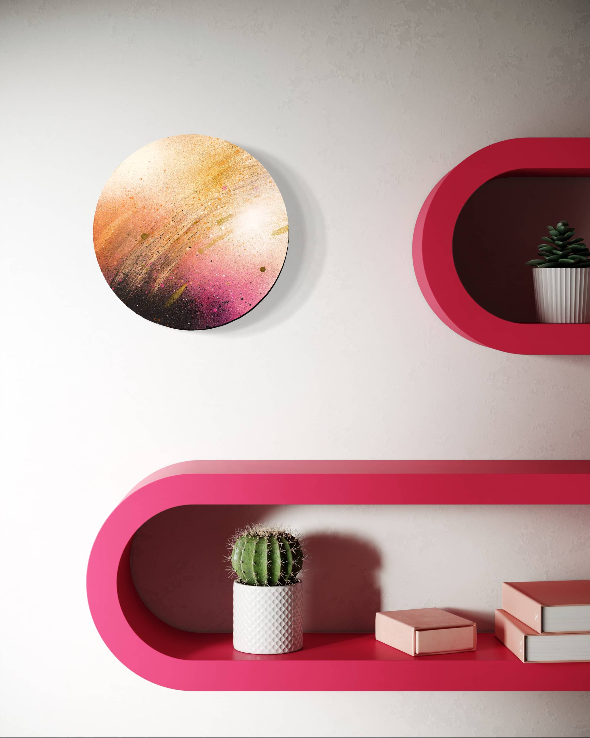 Potamoi by Kate Mayer, a round abstract painting, hangs on a white wall above pink shelves with plants and books.