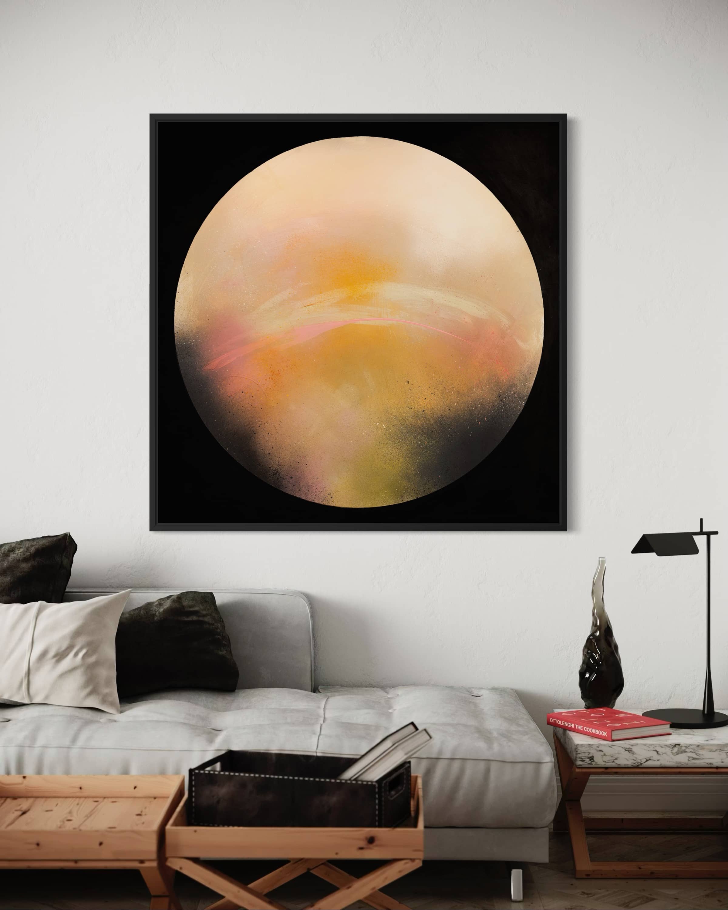 A modern living room with a gray sofa and Kate Mayer's "Sun It Rises" abstract painting on a circular plywood panel above.