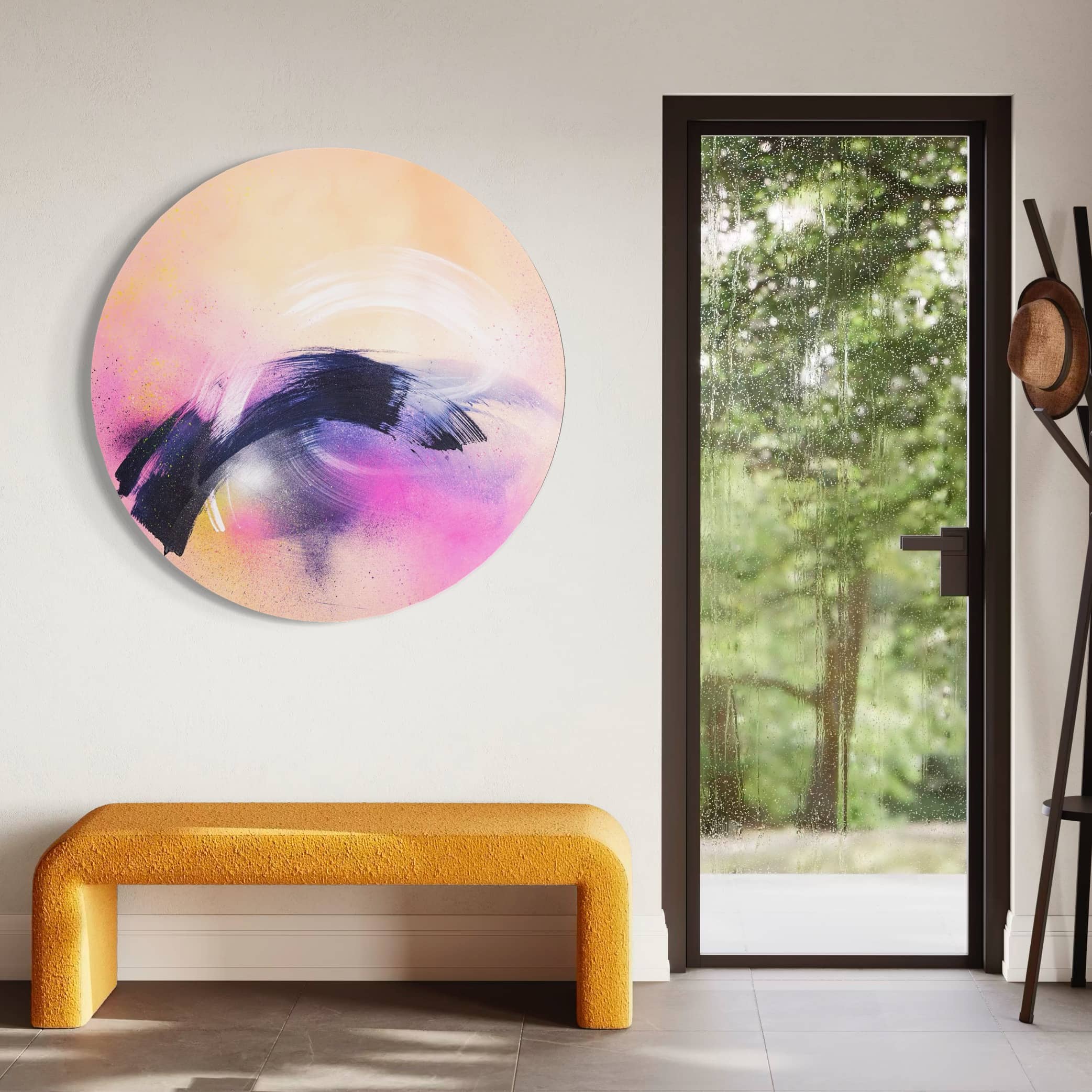 Breathe In The Air" by Kate Mayer—a circular painting with purple, black, and pink hues in a handmade metal float frame near a yellow bench.
