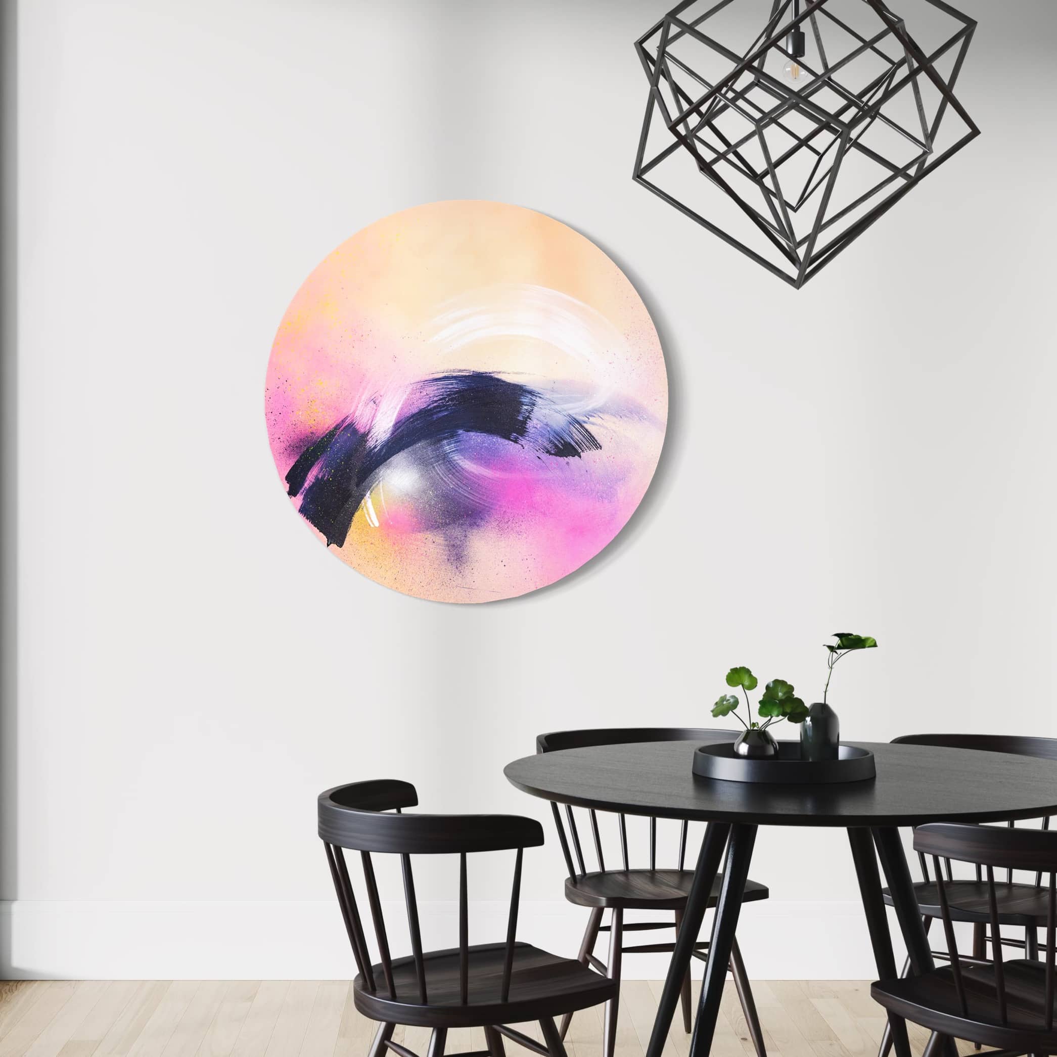 Breathe In The Air" by Kate Mayer in a handmade metal frame, featuring a pink and black circle, is above the dining table.