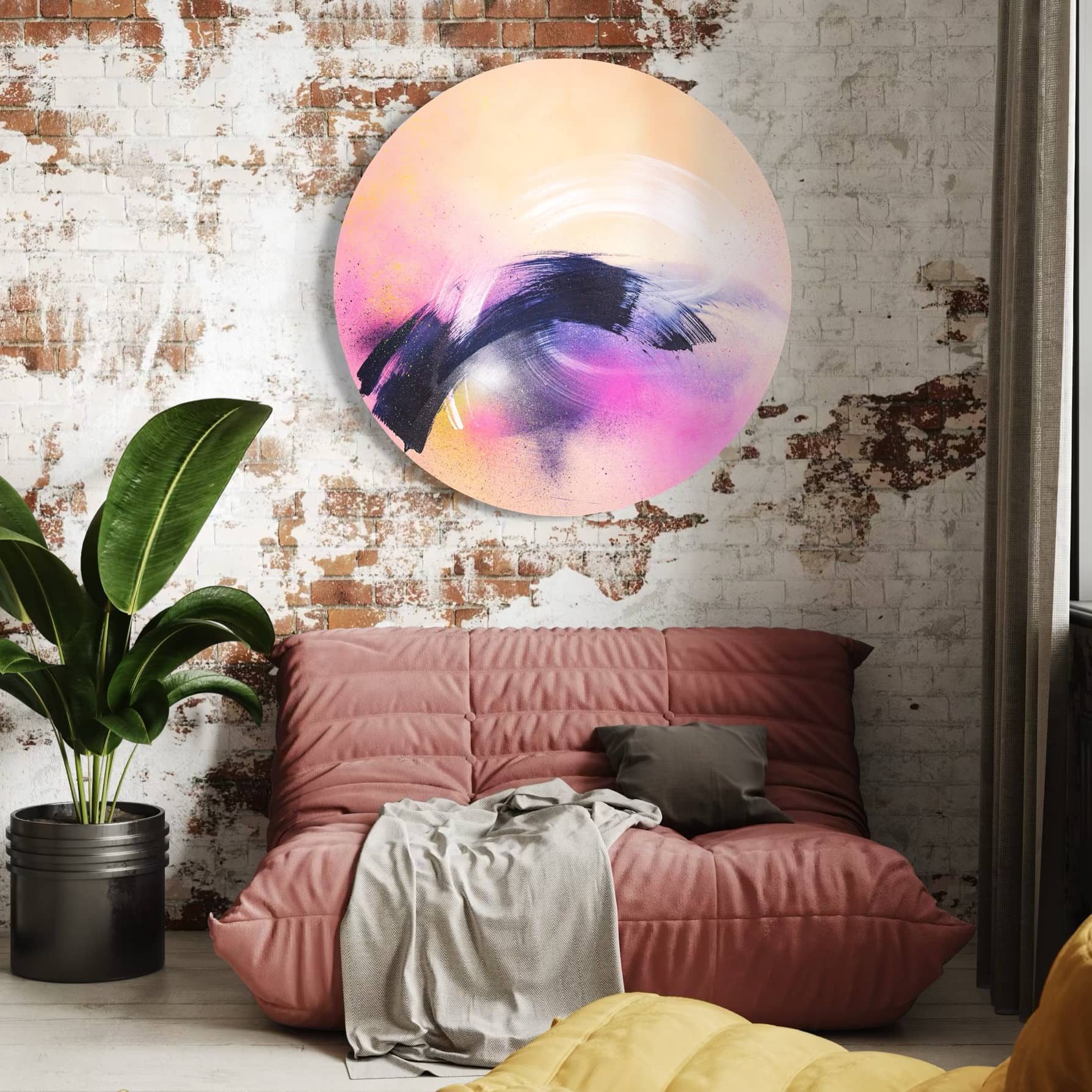 Modern loft with a brick wall, cozy seating, Breathe In The Air by Kate Mayer, and neutral-toned cushions and throws.