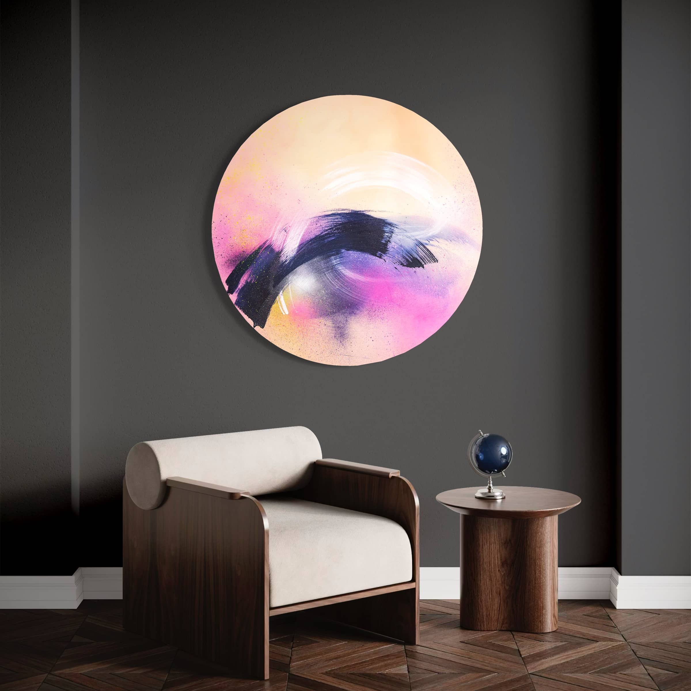Kate Mayer's "Breathe In The Air" painting in a handmade metal frame on a dark wall, beside a modern chair and small table.
