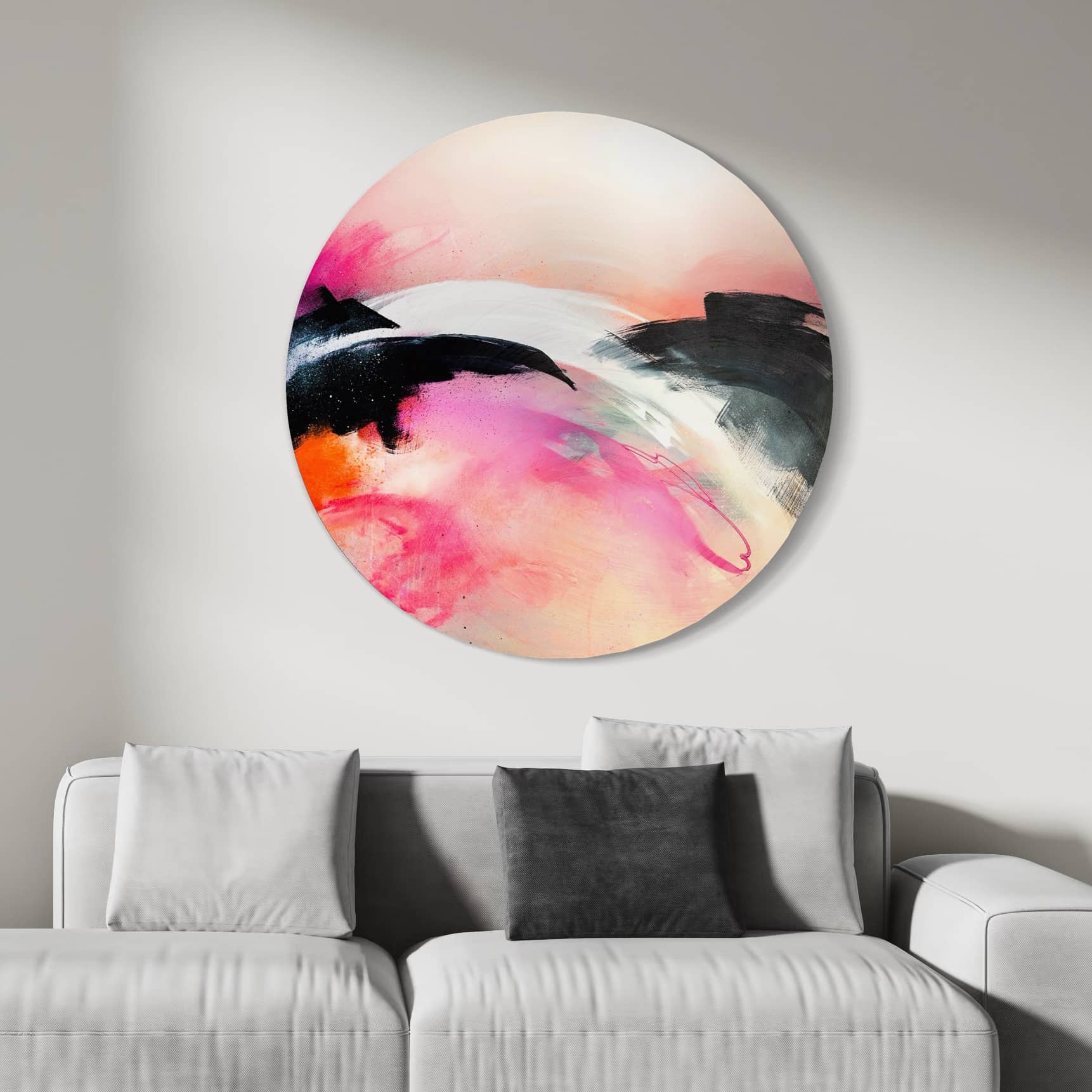 Kate Mayer's 'It's A New Dawn' painting in a custom frame hangs above a gray sofa with contrasting pillows.