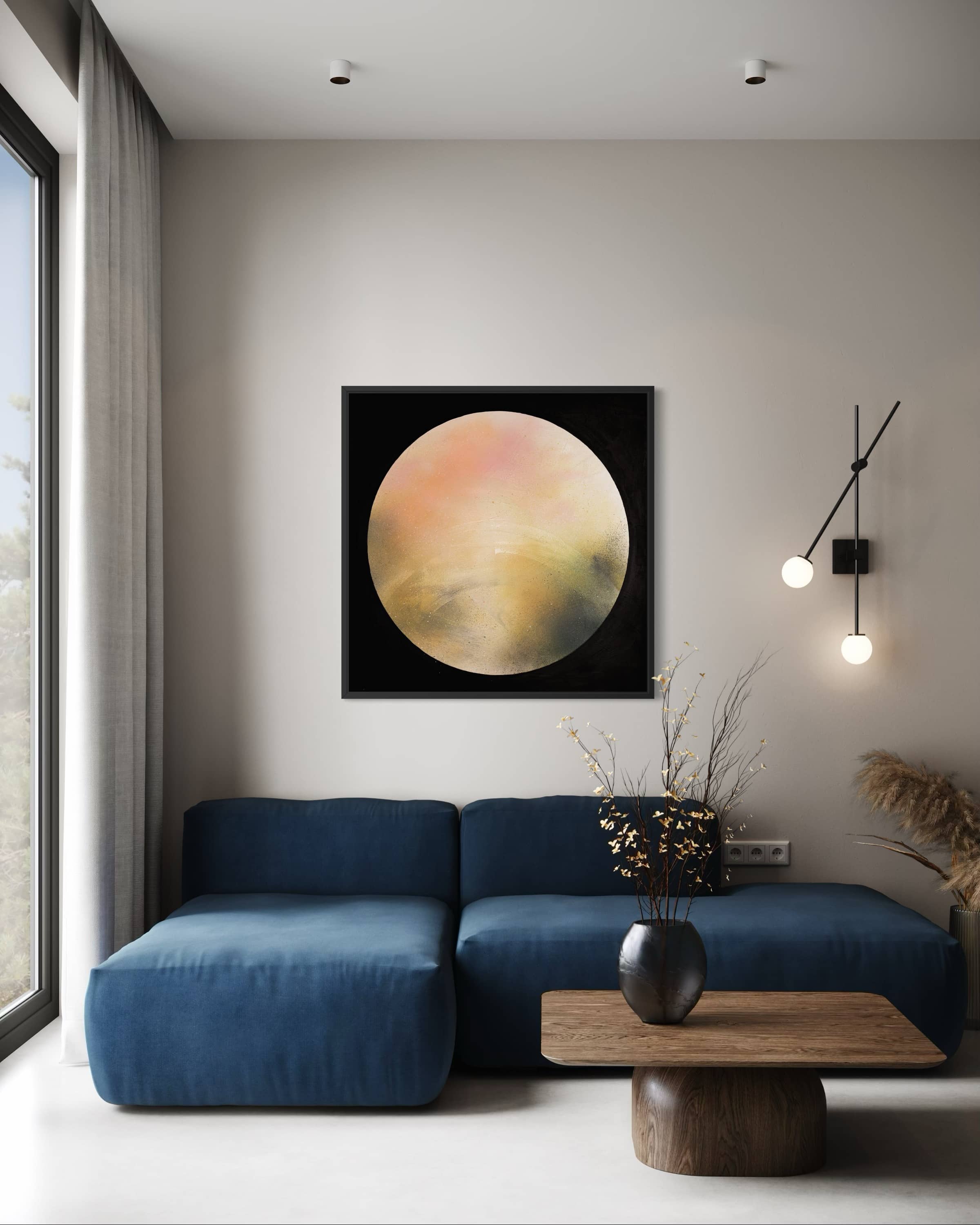 Modern living room with a blue sofa, round wooden table, and Keep Time On Me by Kate Mayer above.