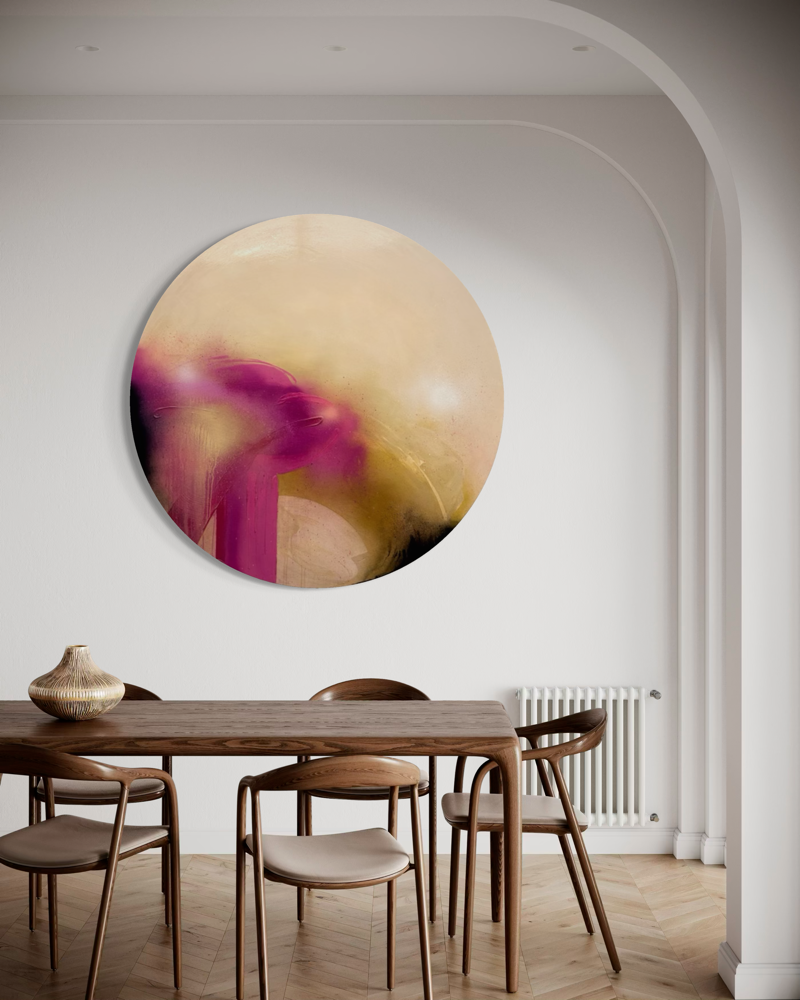 Afterglow by Kate Mayer, a round abstract with pink, beige & gold tones plus diamond dust, hangs above a dining table.