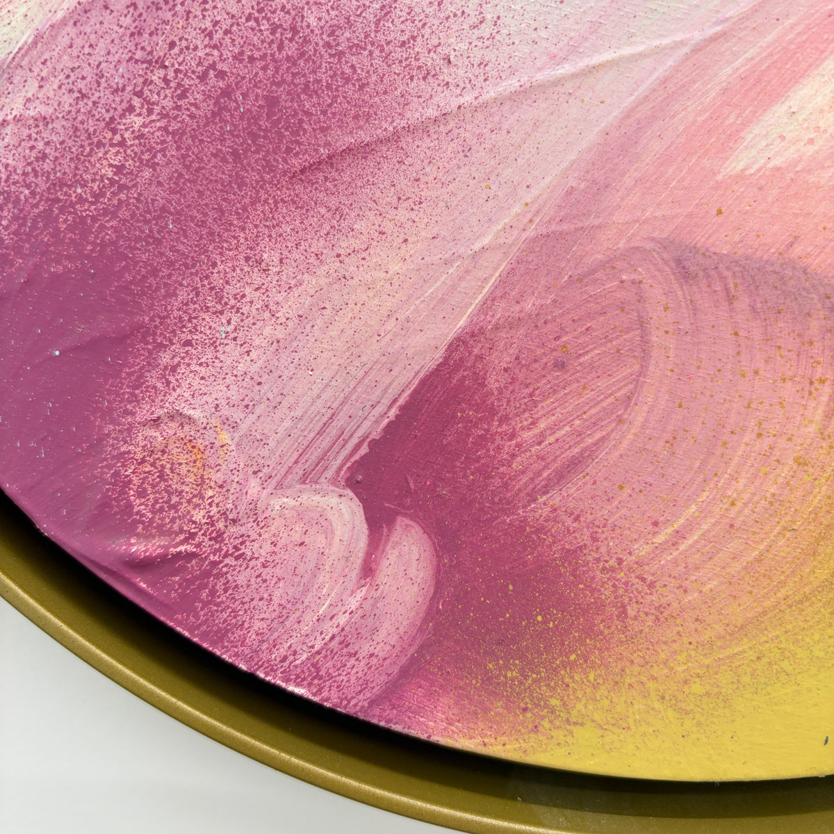 The Power Of One“ by Kate Mayer: round tray with acrylic on plywood, pink/yellow/white abstract painted swirls.