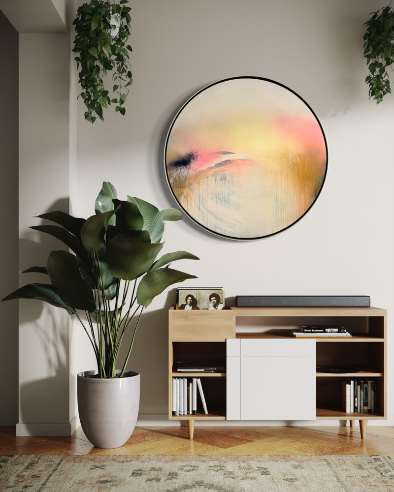 A large plant and console sit beneath “Shadows” by Kate Mayer in a bright, modern living room.