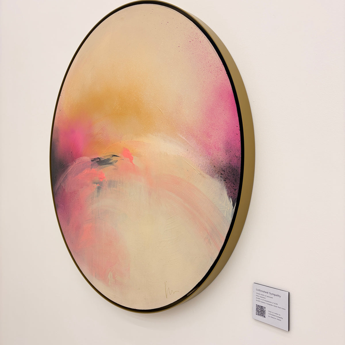 Unfinished Sympathy“ by Kate Mayer: circular abstract in pink, orange & cream, with metal float frame and visible label.