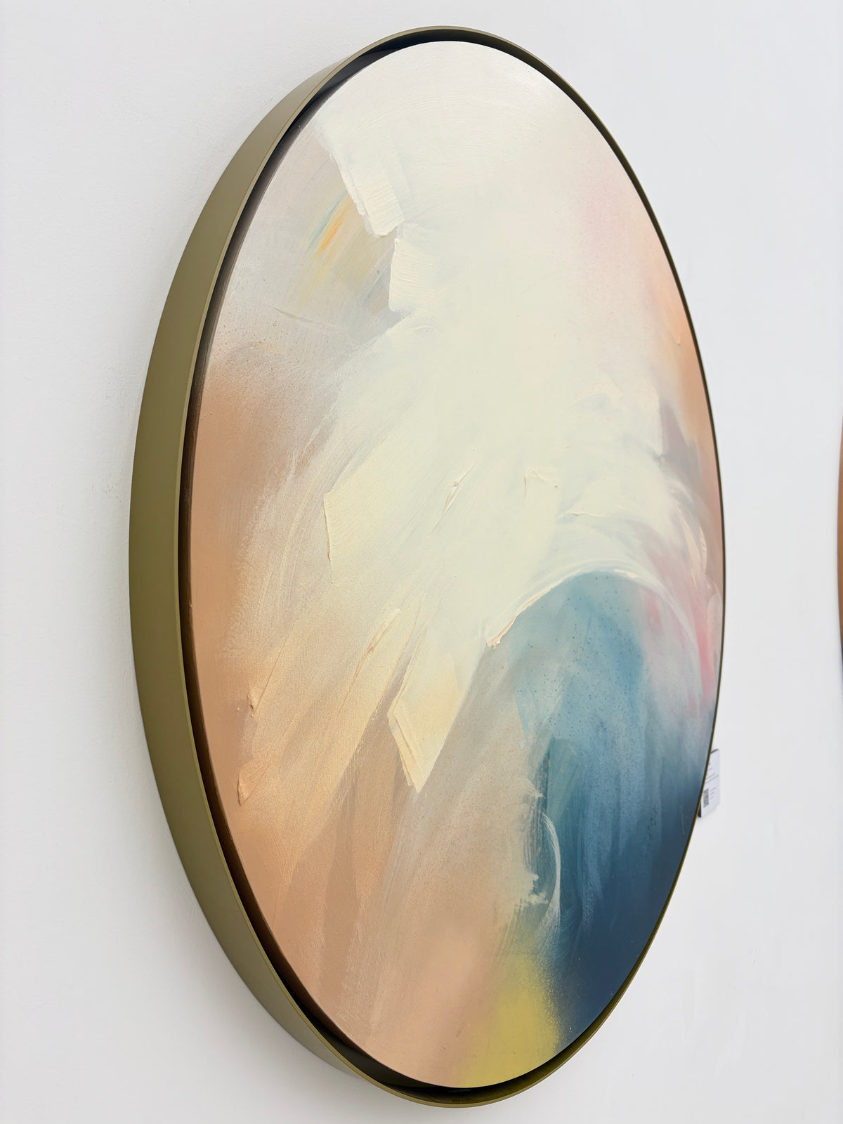 Total Praise“ by Kate Mayer: Round abstract acrylic on plywood, cream/peach/blue, framed in handmade metal float frame.