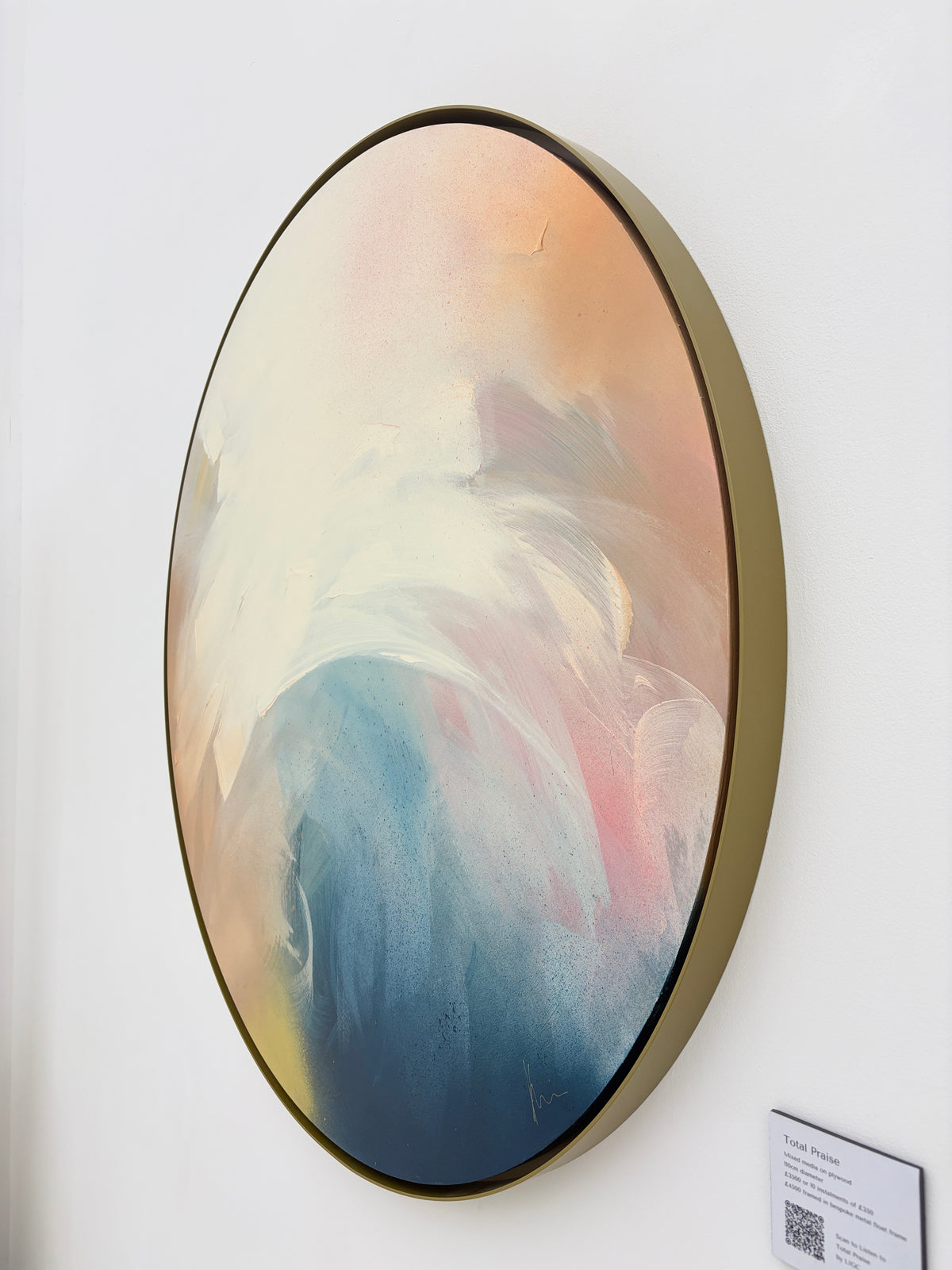 Kate Mayer “Total Praise”—round abstract acrylic on plywood with pastel swirls, gold rim; wall-mounted.
