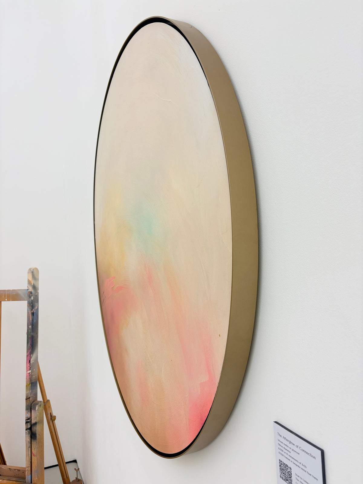 The Afterglow of Connection by Kate Mayer: a pastel acrylic on plywood, in a handmade metal float frame, hangs on white.