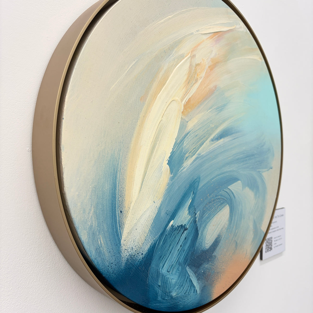 The Best Is Yet To Come“ by Kate Mayer: round acrylic on plywood, blue/white/beige, metal float frame.