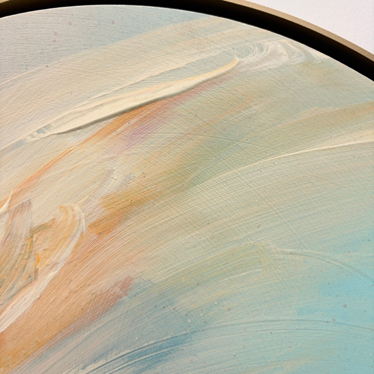 The Best Is Yet To Come“ by Kate Mayer: pastel abstract on round canvas in a handmade metal float frame.
