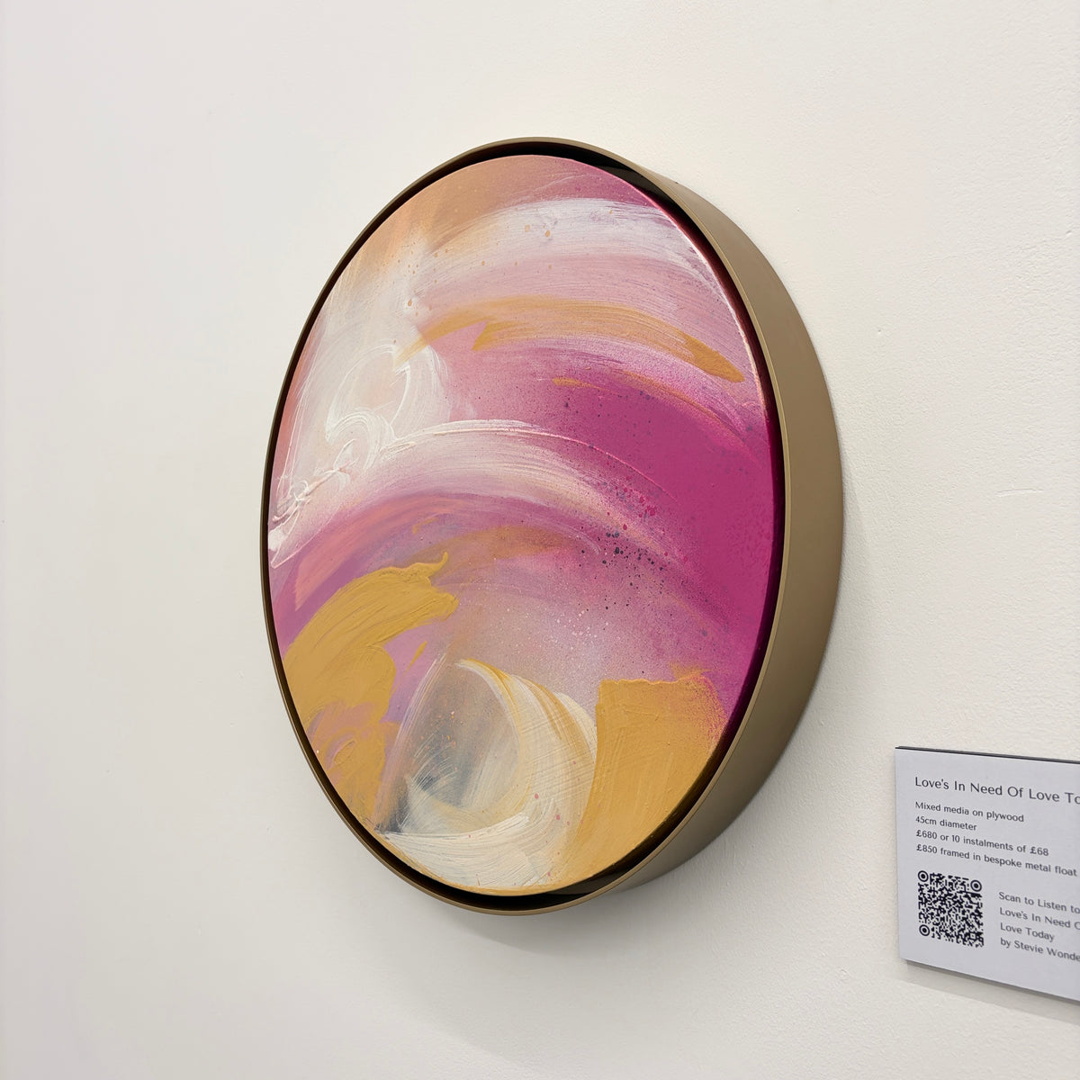 Love’s In Need Of Love Today by Kate Mayer: Round acrylic on plywood, pink/white/gold swirls, metal frame, QR code.