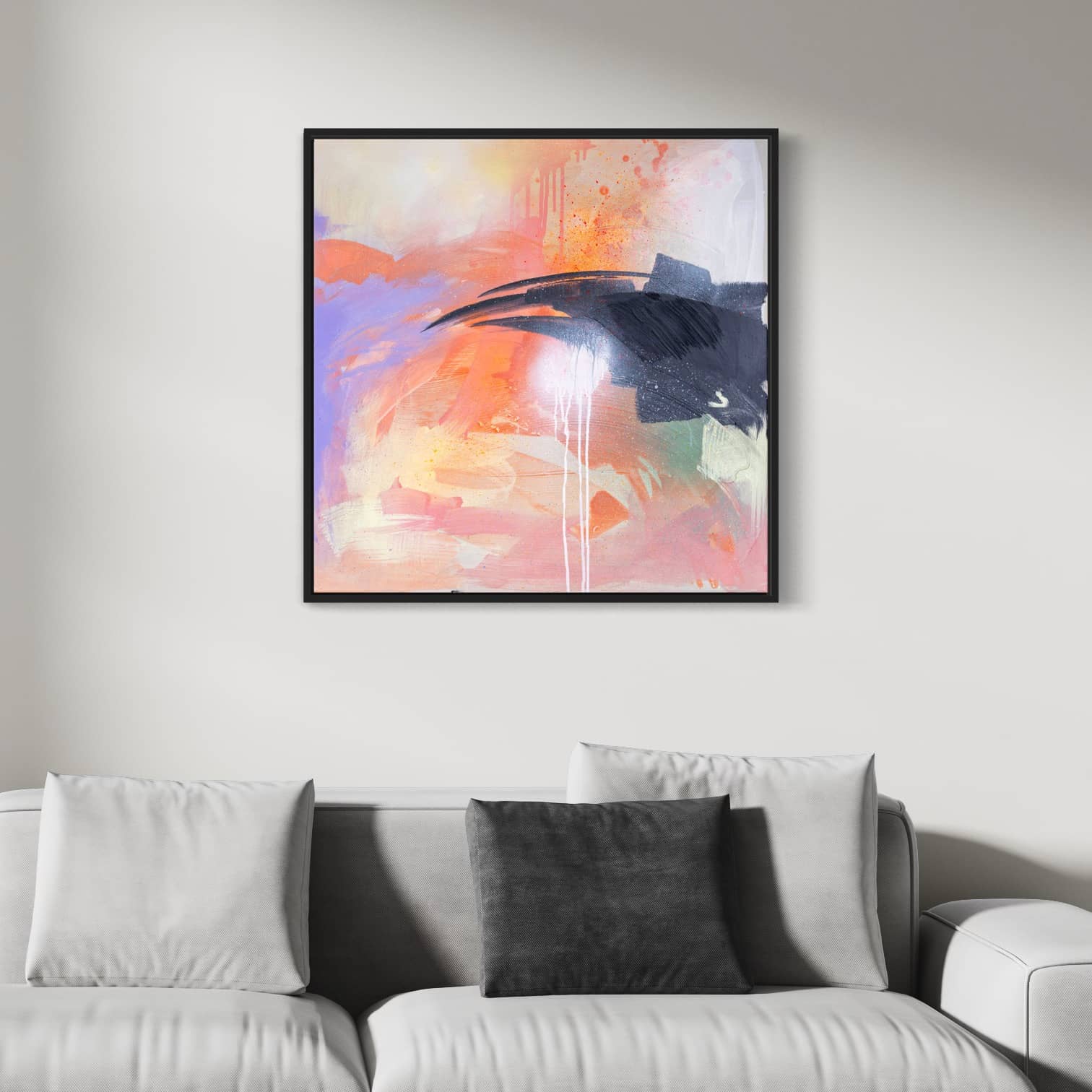 Beneath The Surface, an original painting by Kate Mayer featuring bold strokes in pink, orange, and blue acrylic on canvas, is elegantly framed above a white sofa adorned with gray pillows.