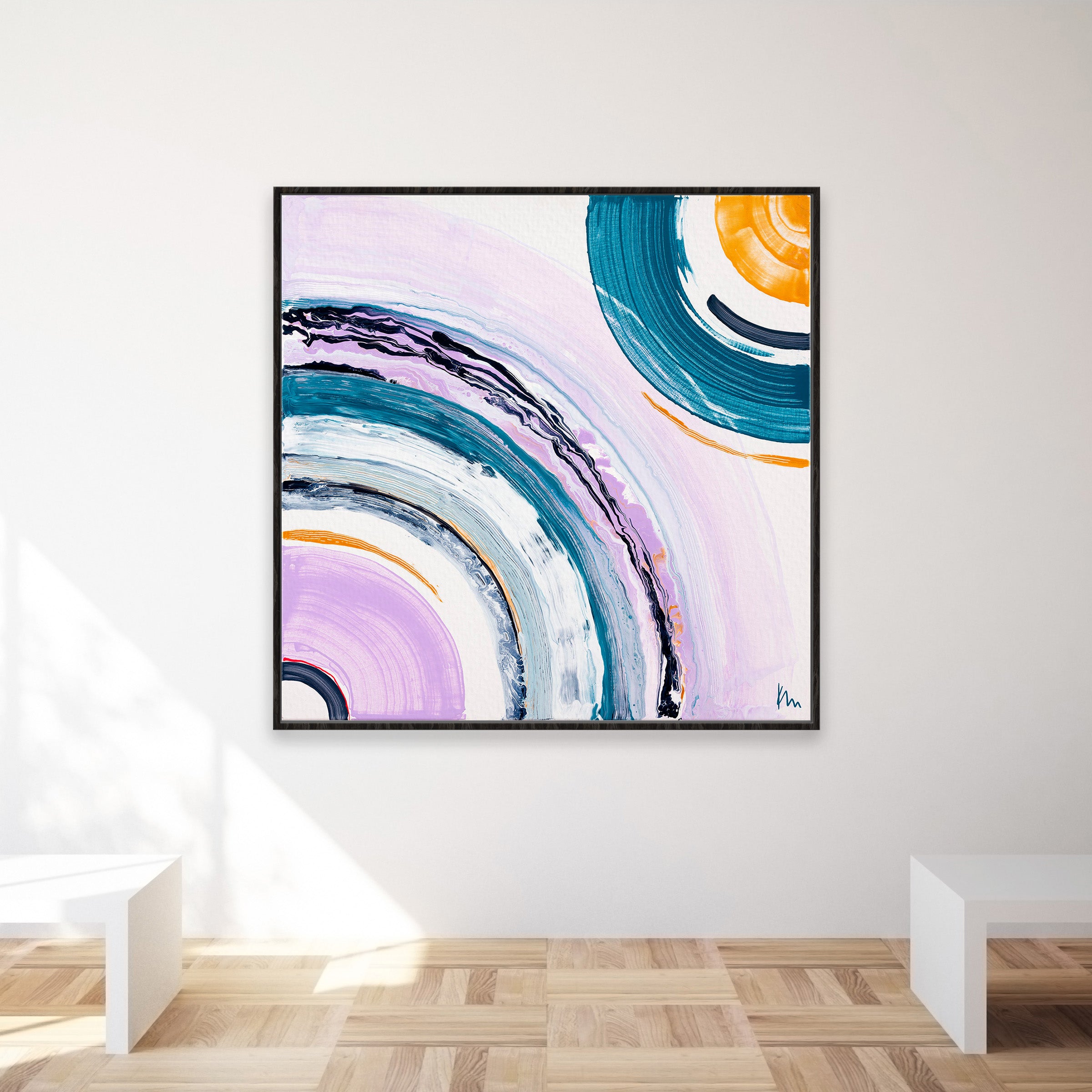 Between Us, a vibrant abstract painting by Kate Mayer, features overlapping circular patterns in blues, purples, and oranges to symbolize human connection. Framed on a white gallery wall, this captivating artwork inspires the imagination.