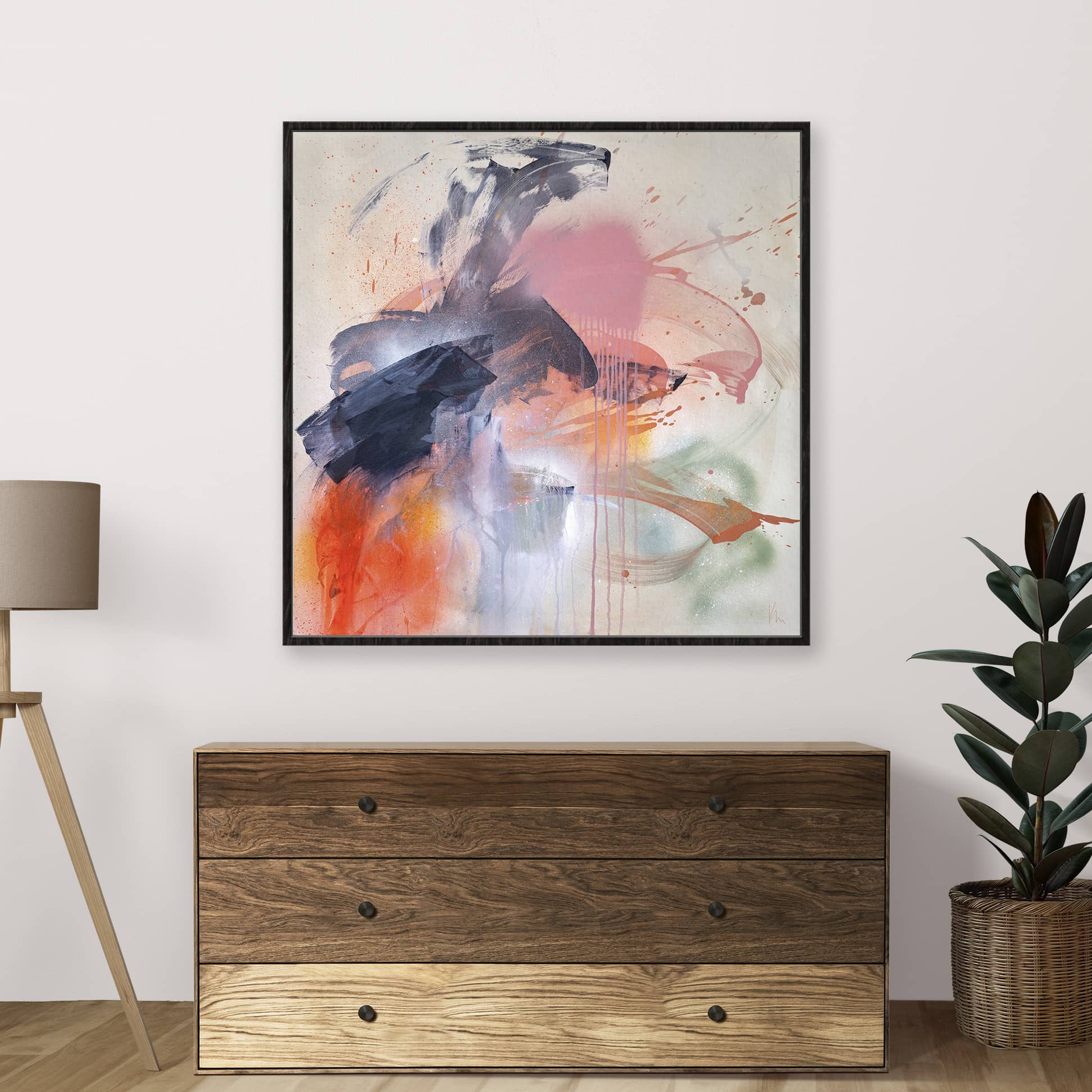 An abstract masterpiece with vibrant colors, titled "Fire And Ice" by Kate Mayer, adorns the wall above a wooden dresser. Nearby, a potted plant and lamp complement the artwork's dynamic energy, evoking a sense of inner power.