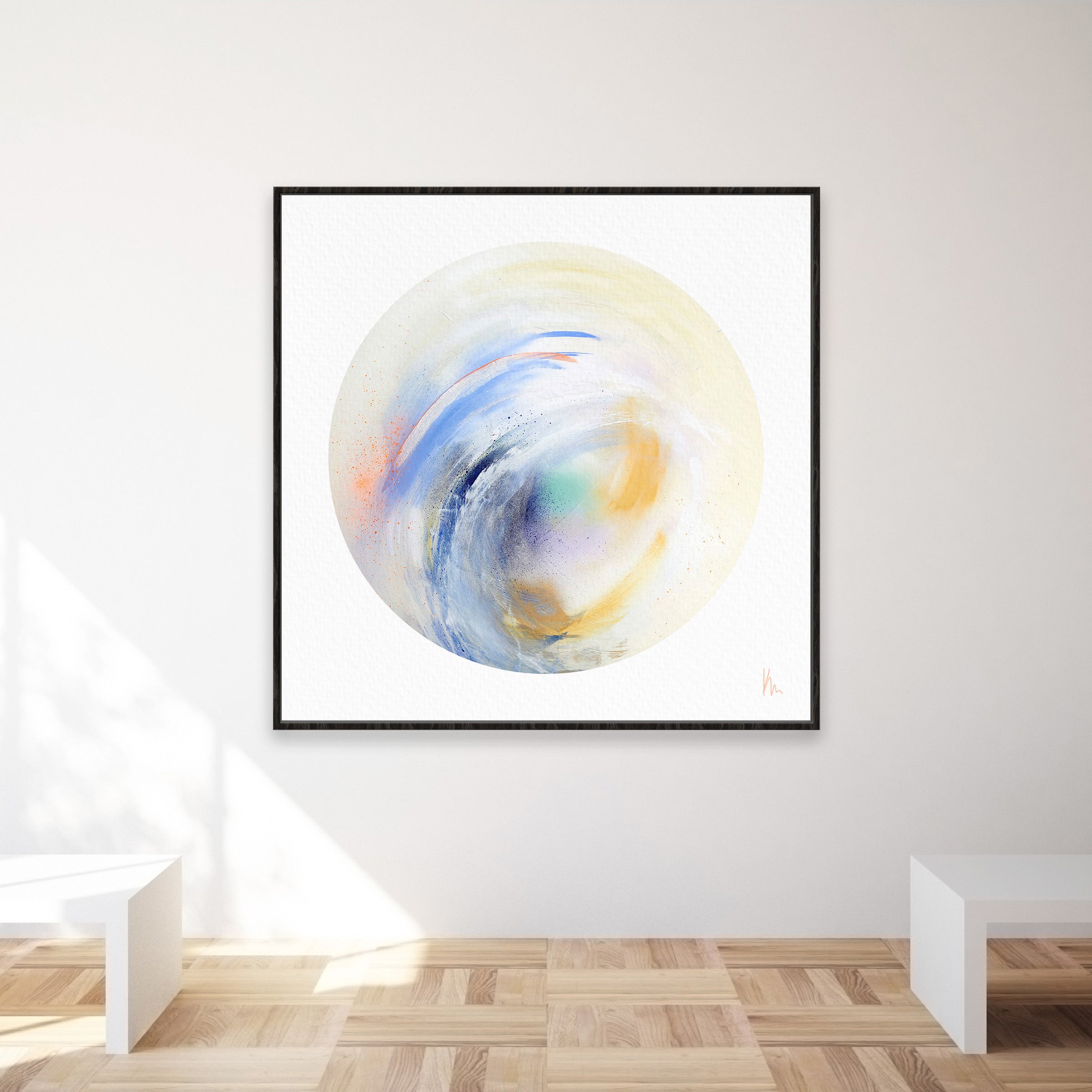 Displayed in the gallery room is a square abstract painting by Kate Mayer, featuring swirling colors that capture coastal beauty. Soft blues, oranges, and yellows dance across the canvas like a Free Spirit by Kate Mayer.