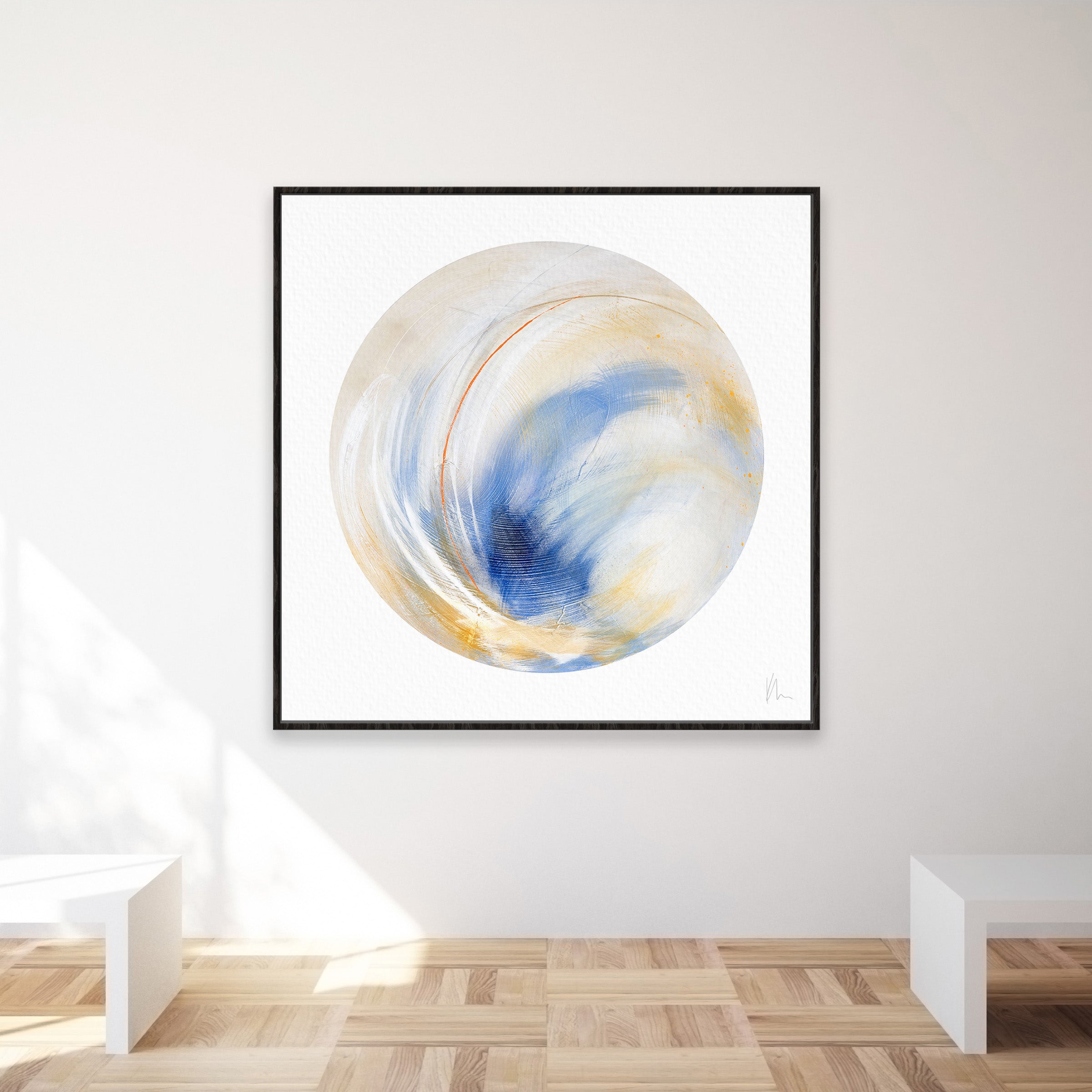 The "Go Your Own Way" piece by Kate Mayer exudes individuality as its framed abstract art, featuring blue, gold, and white swirling patterns, hangs on a minimalist wall complemented by wooden flooring and benches.