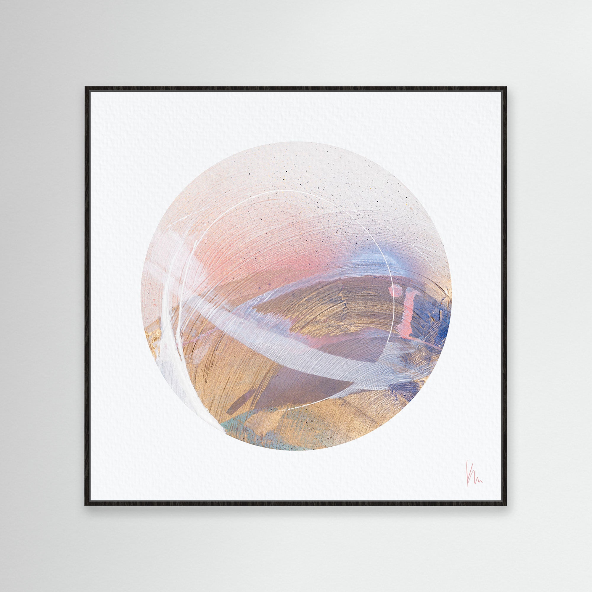 The "Just Be" artwork by Kate Mayer features an abstract circular design with earthy hues of pink, brown, and blue. It is elegantly framed in black against a light gray backdrop, inviting mindfulness and inner reflection while exuding tranquility through its harmonious composition.