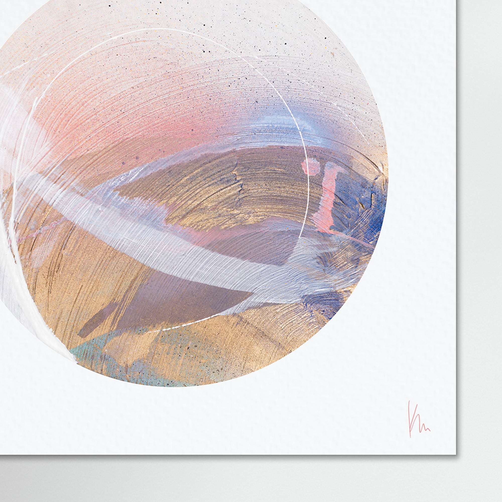 The mindfulness art piece "Just Be" by Kate Mayer is an abstract painting featuring a circular design created with spray paint and acrylic techniques. It showcases pastel pink, blue, and gold brushstrokes set against a textured white background.