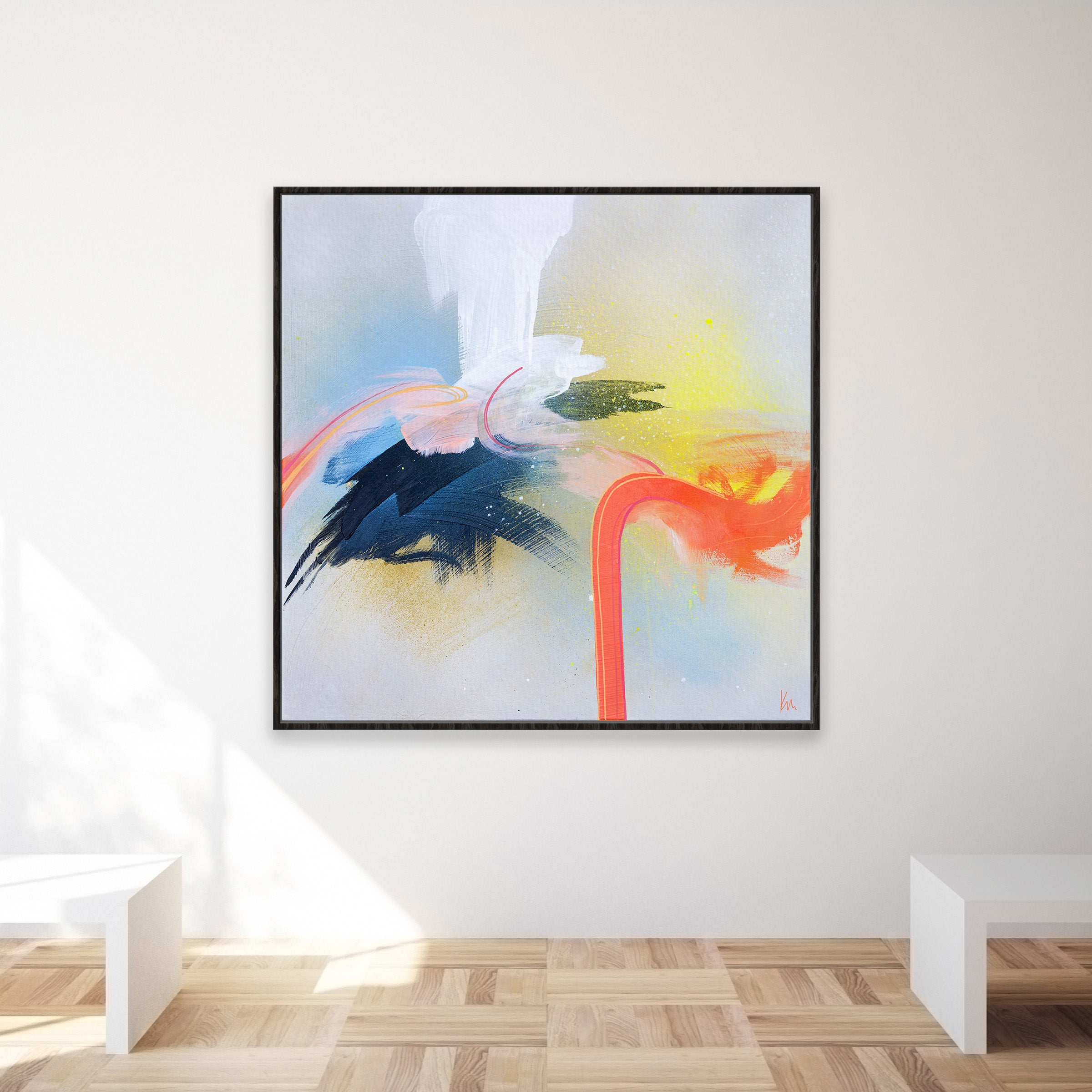 The Miami Flamingo painting by Kate Mayer, featuring bold brushstrokes in blue, red, yellow, and white, graces the wall. A light wood floor enhances the vivid artwork, while white benches provide a spot to appreciate this masterpiece.