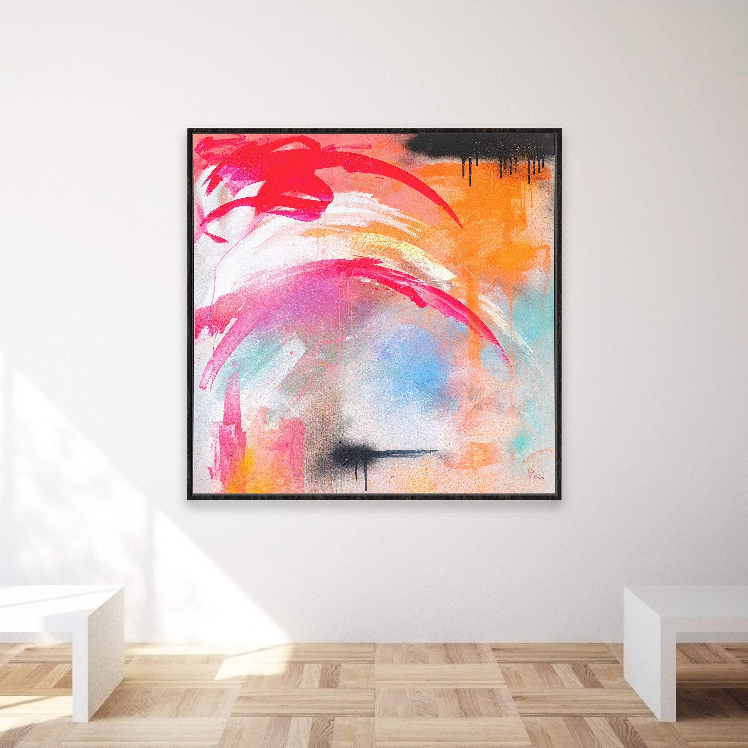 The "Never Too Much" painting by Kate Mayer showcases a vibrant mix of red, orange, pink, and blue strokes and adds an elegant touch to a minimalist room when hung on the wall.